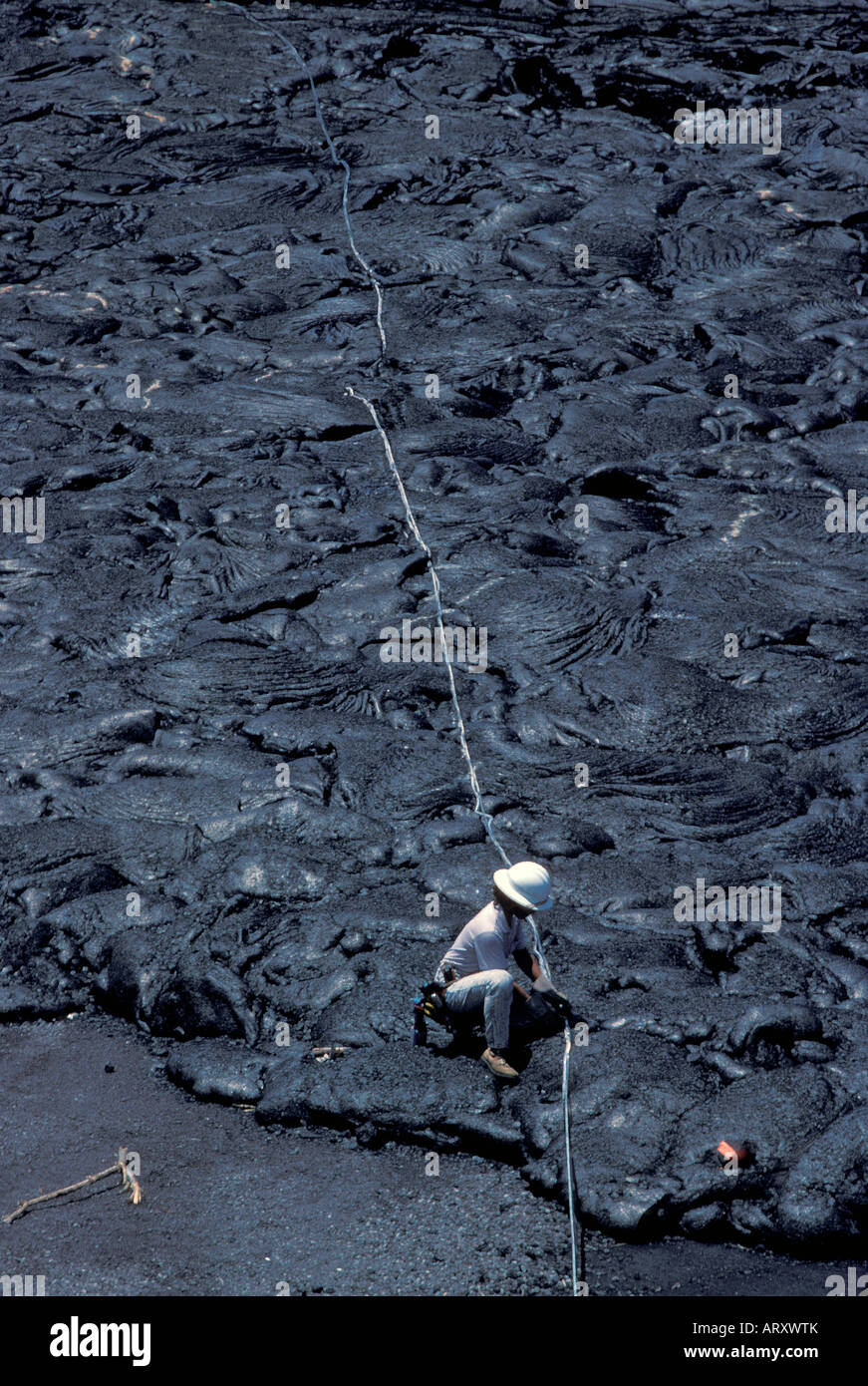Telefon Reparatur Frau arbeiten in Zeilen in gehärteten Lava. Kalapana, Big Island Stockfoto