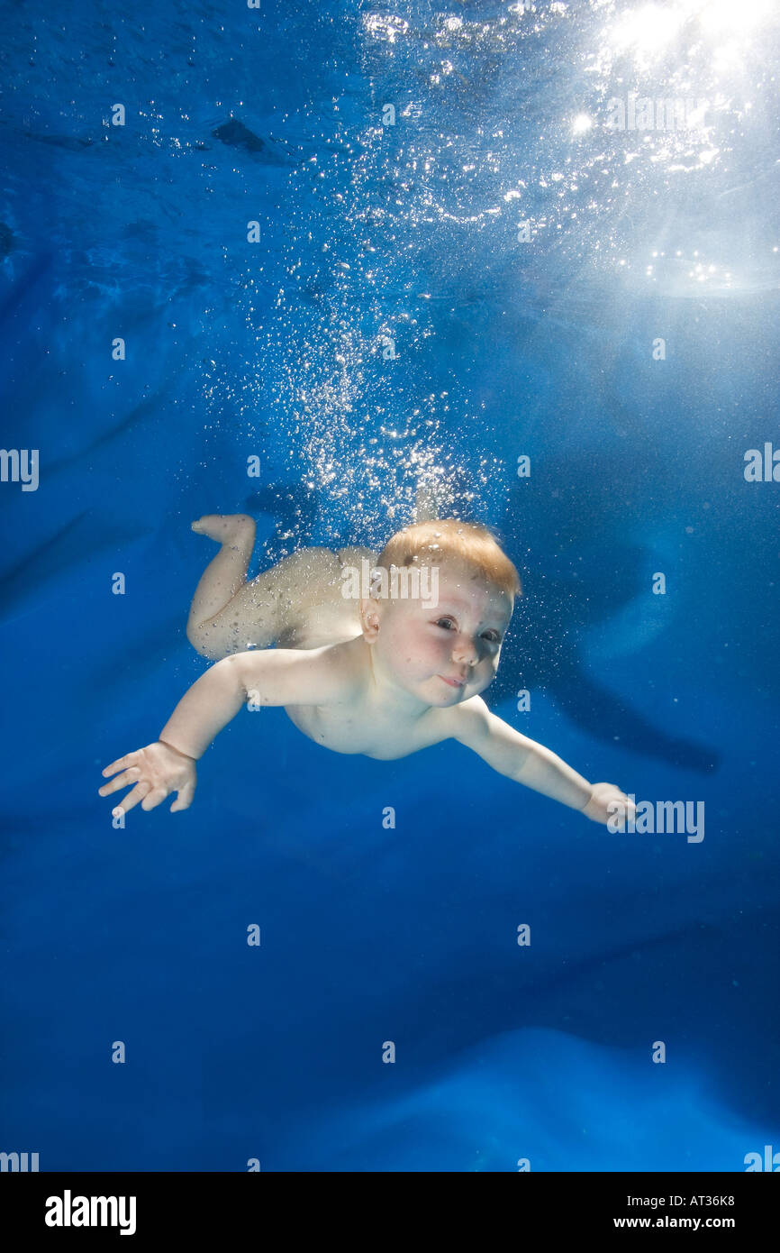 Baby unter Wasser im Pool auf blauem Hintergrund Stockfoto