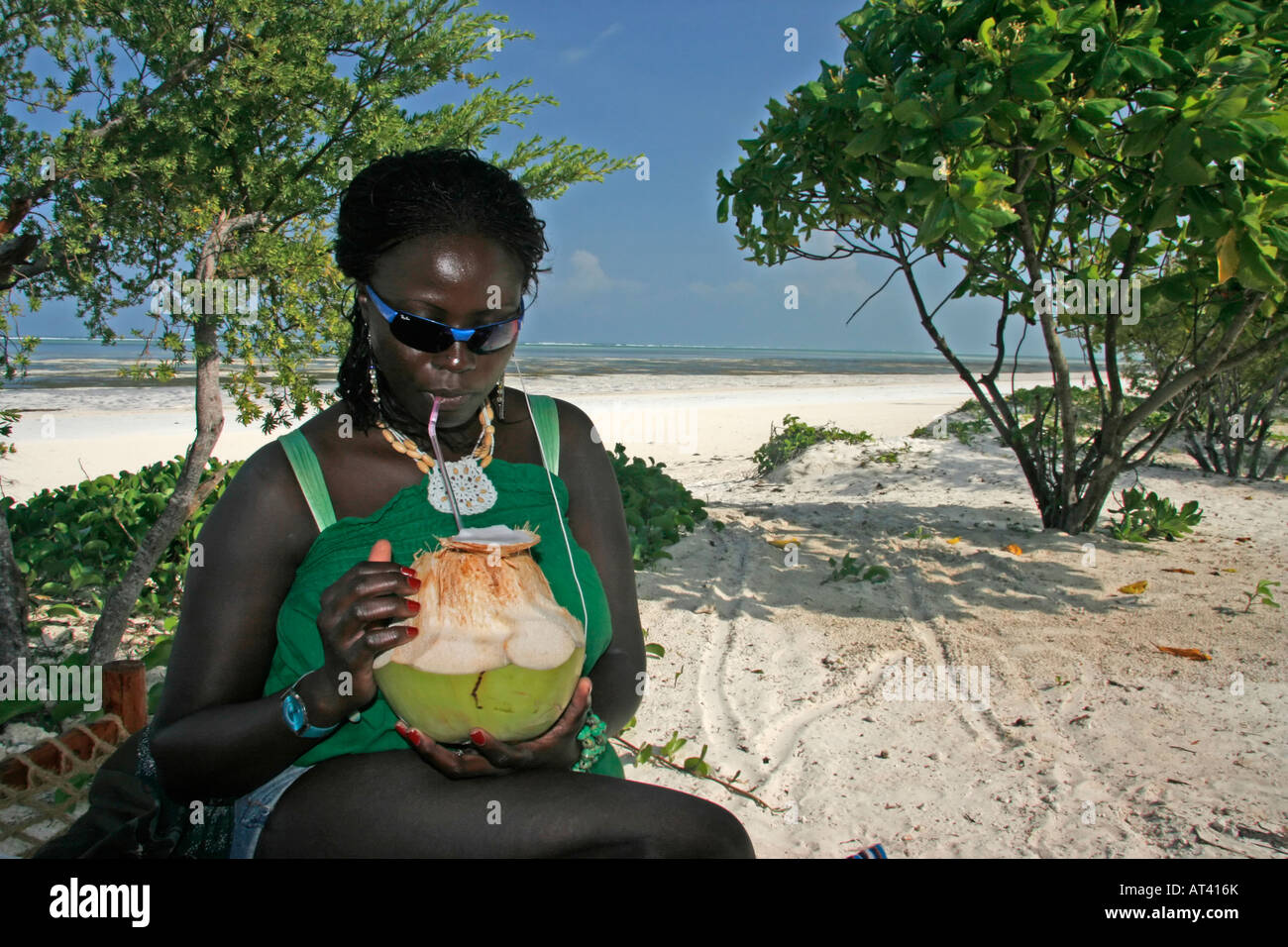 Frische Kokosmilch trinken, an einem Strand auf Sansibar Stockfoto