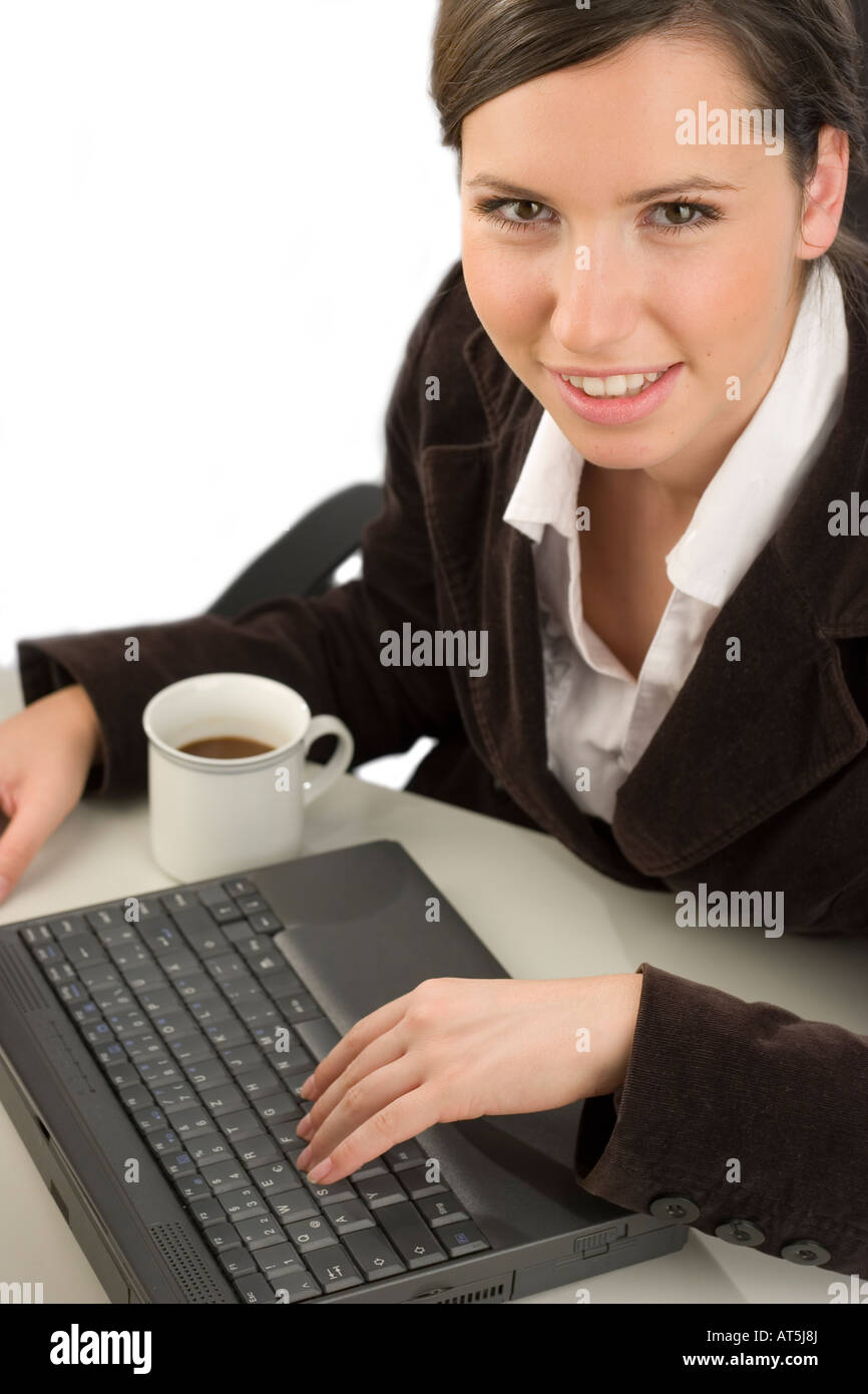 Junge lächelnde Frau mit einem Computer in einem Büro arbeiten Stockfoto