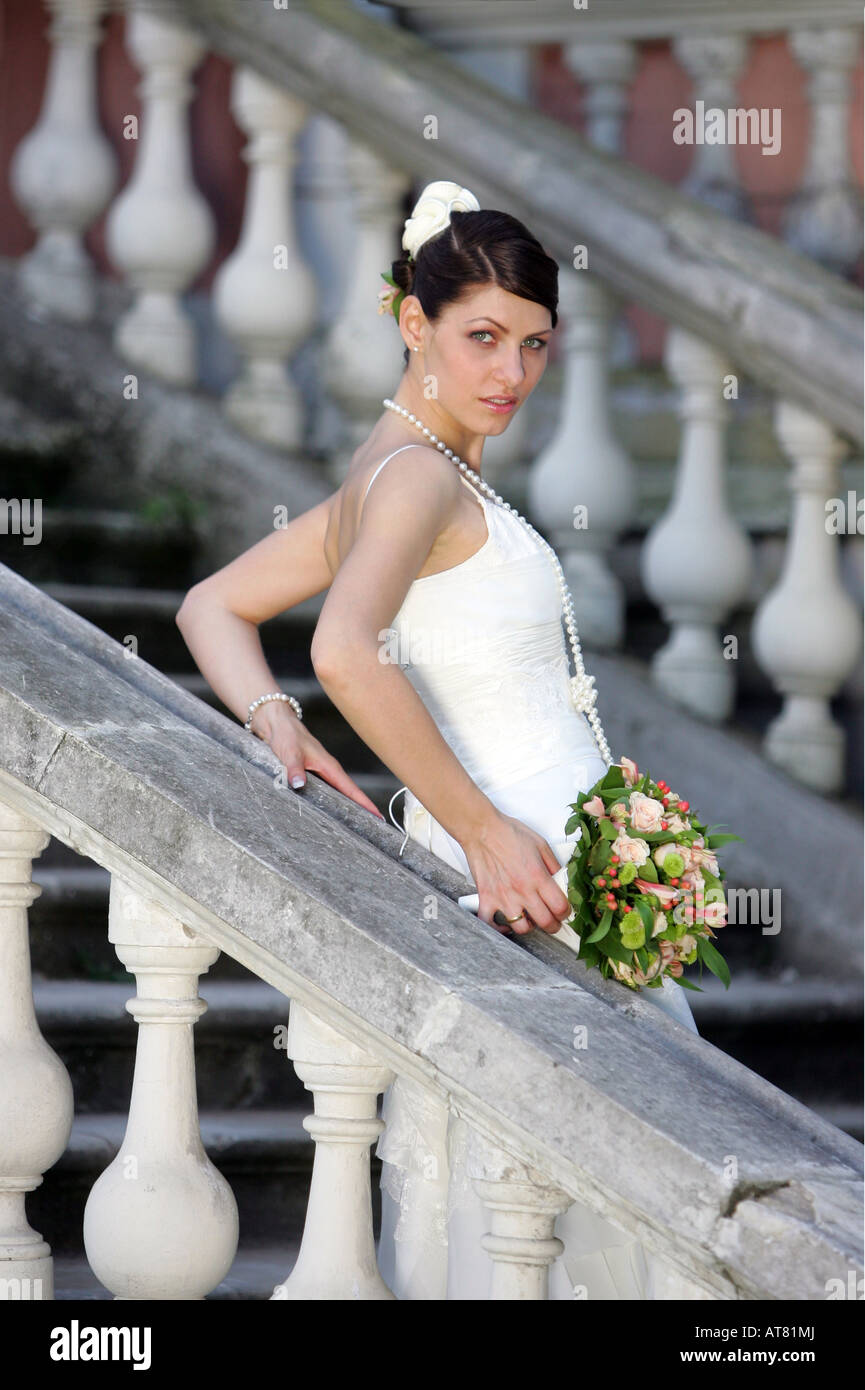 Schöne junge lächelnde Braut am Tag der Hochzeit tragen traditionelle weiße Kleidung. Stockfoto