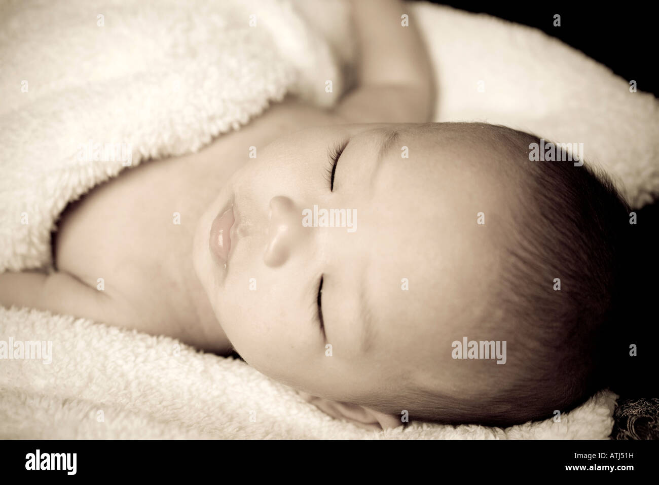 Asiatische Babyjungen schlafen in decken. Stockfoto