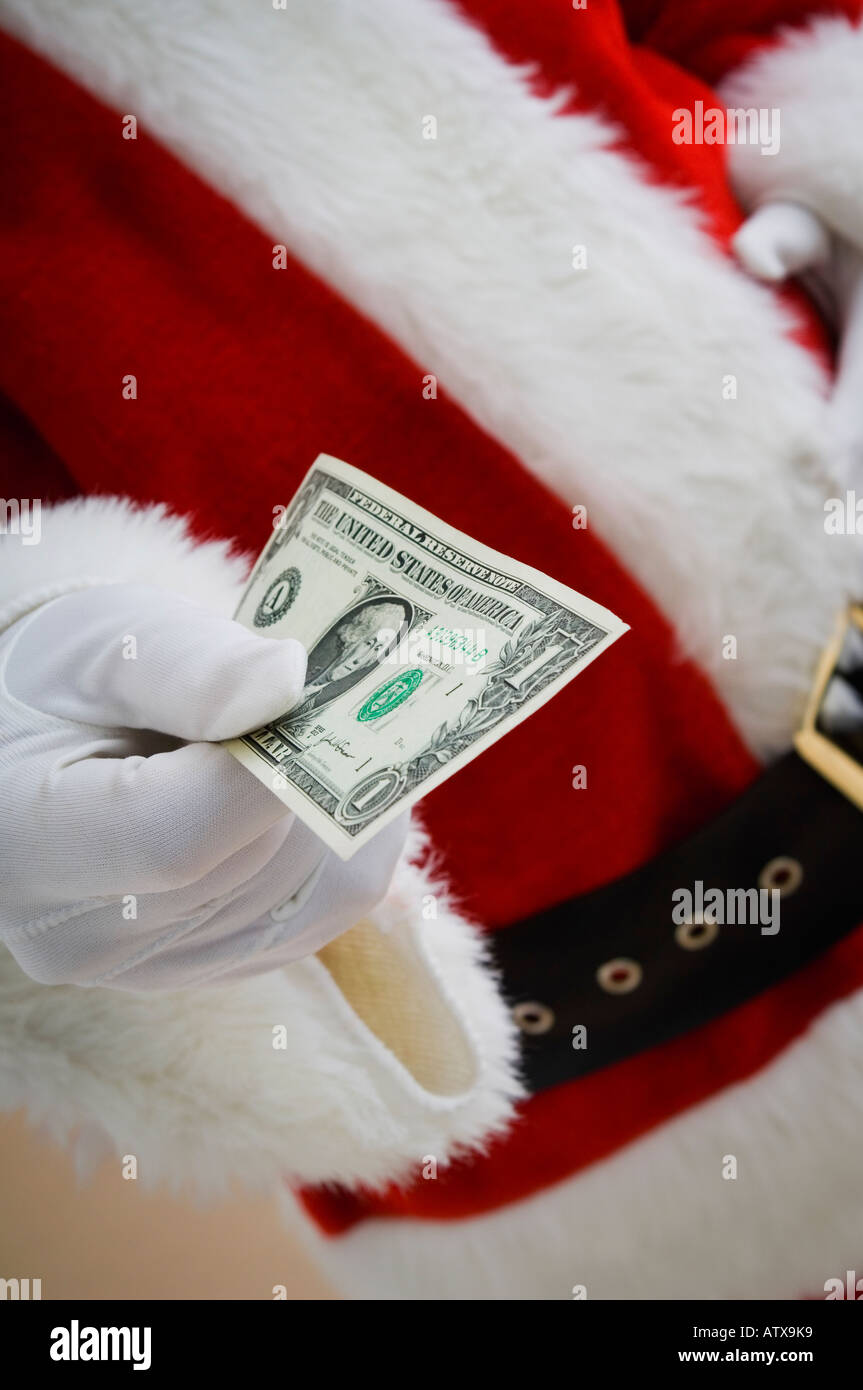Santa Geld austeilen Stockfoto