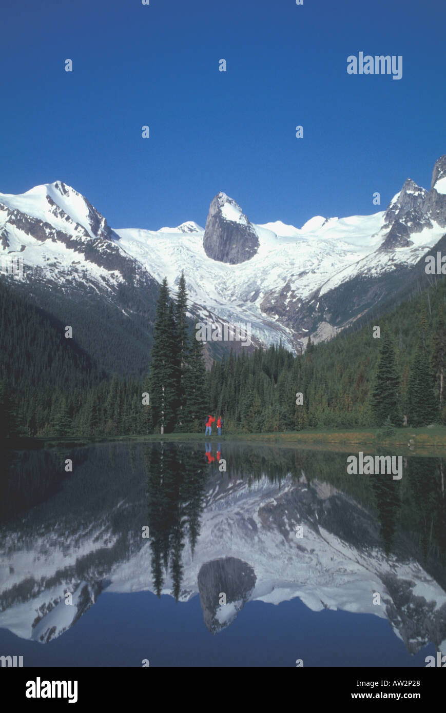 Wanderer im roten Parkas stehen unter Gletscher und unverwechselbaren rock Turmspitze Bugaboo Bergen Kanada See Reflexion Reflexion Stockfoto