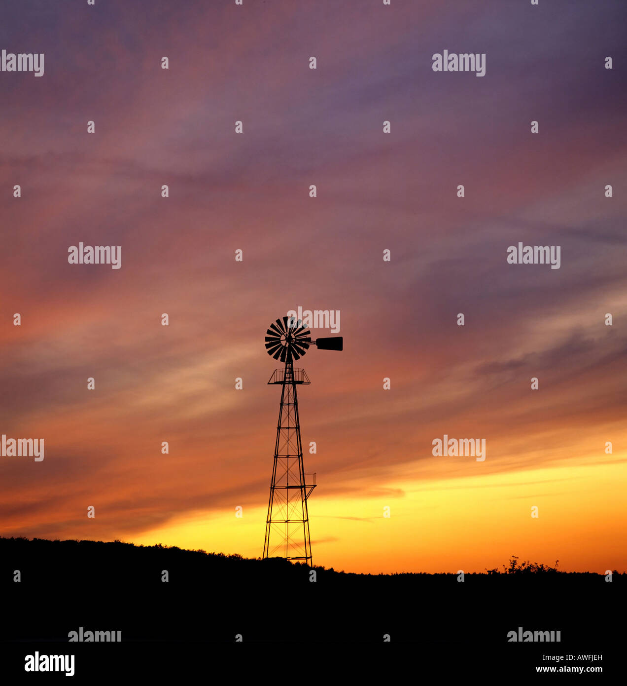 Wind-Pumpe Silhouette gegen bunte Nachthimmel Stockfoto