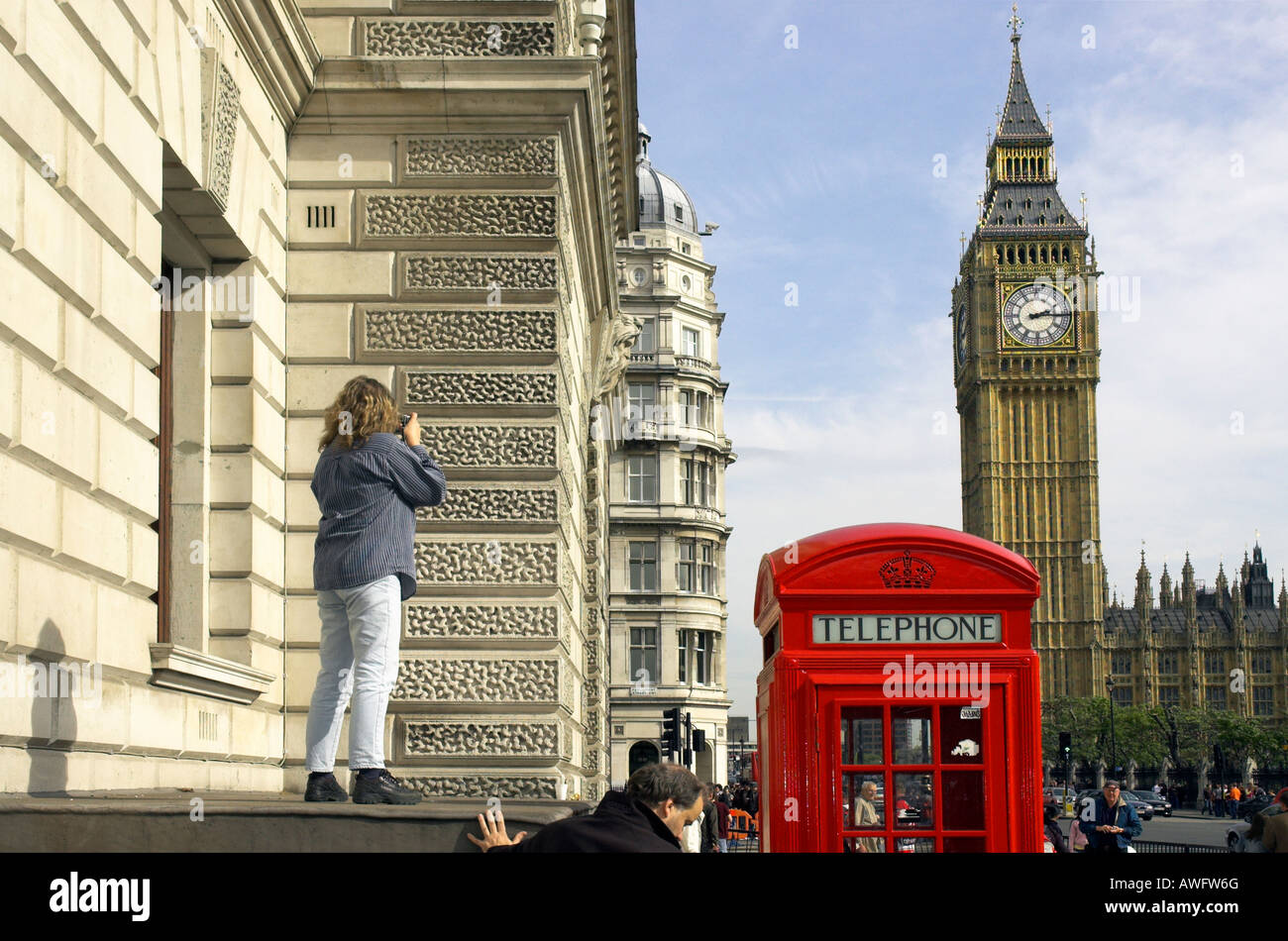 Ein Tourist Stoof auf einem Dach durch eine rote Telefonzelle, ein Foto von Big Ben Stockfoto