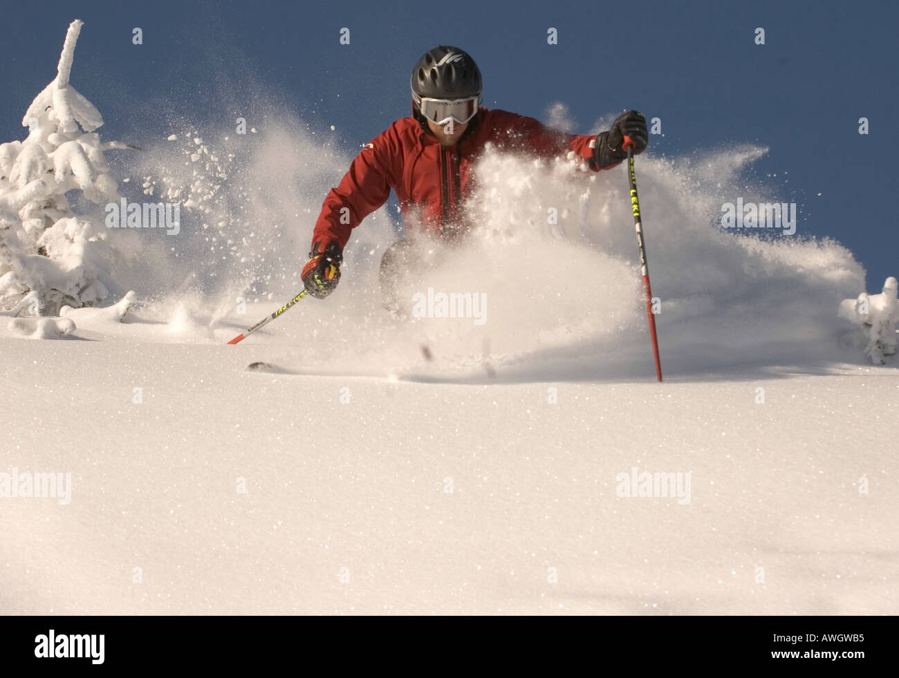Skifahrer John Egan kicks bis Schnee, wie er das Pulver auf Sugarbuh Resort Lincoln Höhepunkt in Warren, Vermont genießt. Stockfoto