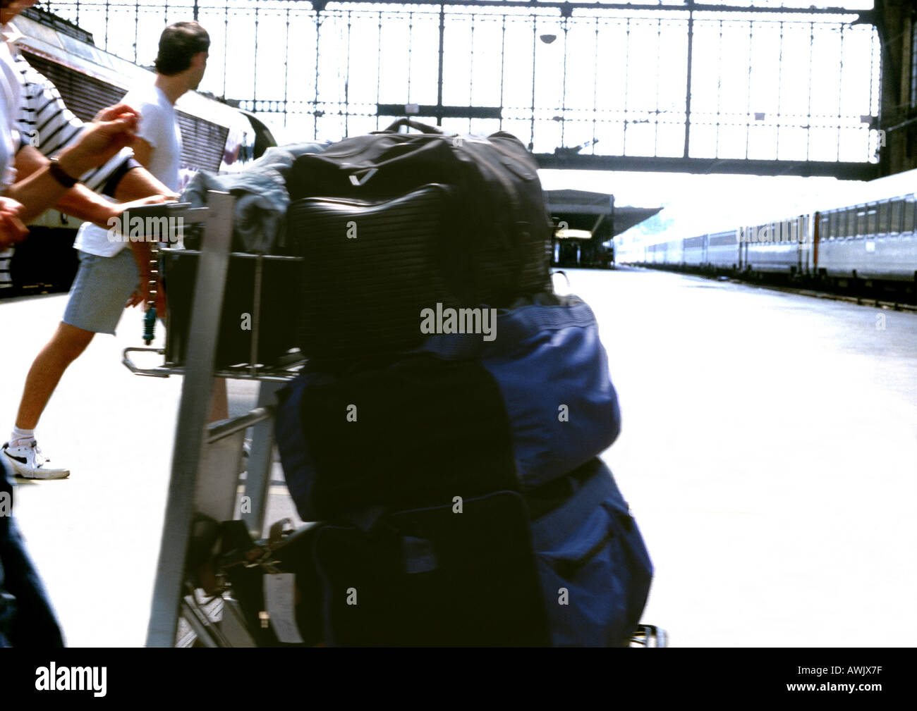Person aufgebracht Gepäck auf Wagen am Bahnhof. Stockfoto