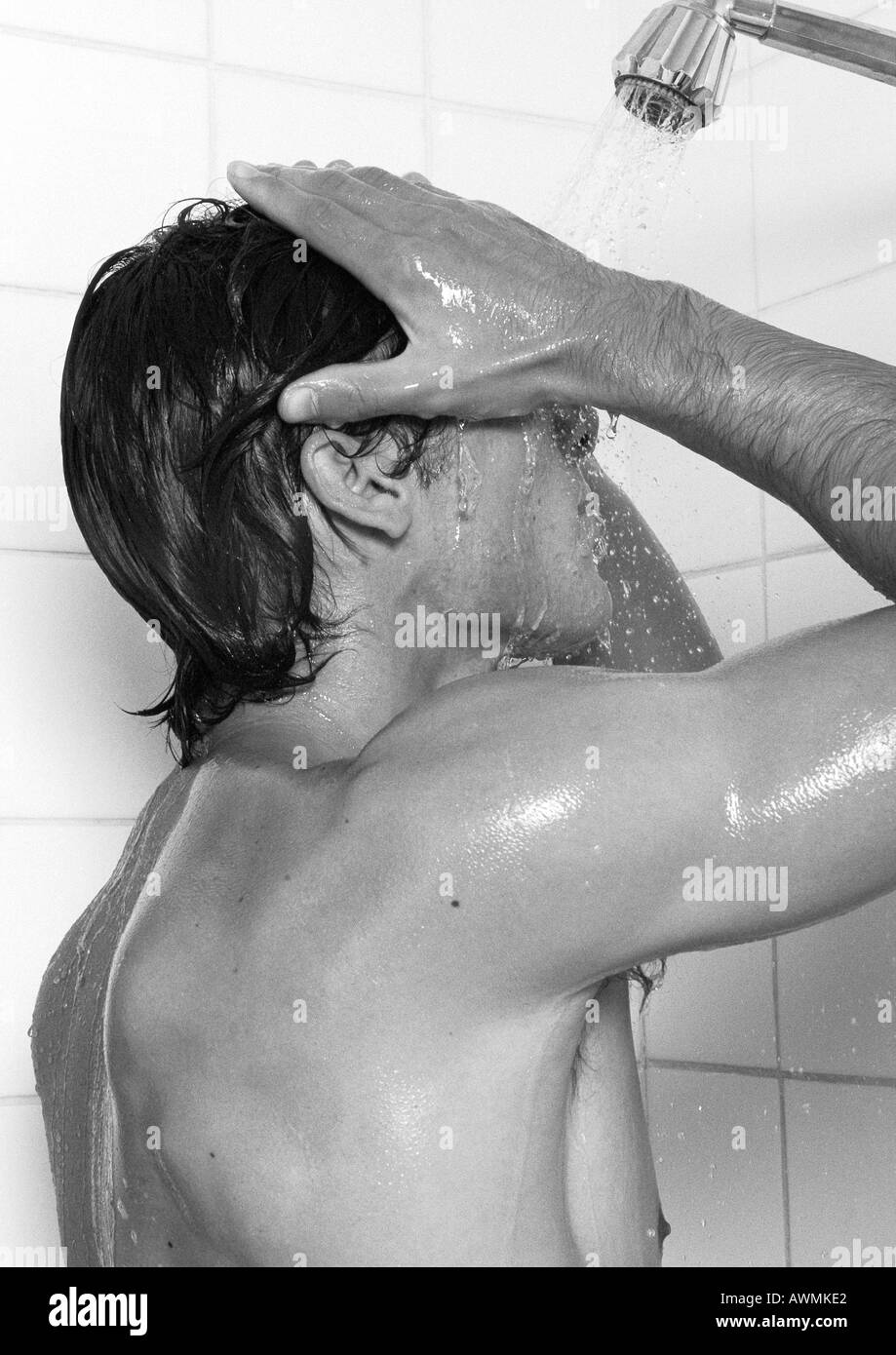 Mann unter Dusche, Seitenansicht, b&w Stockfoto
