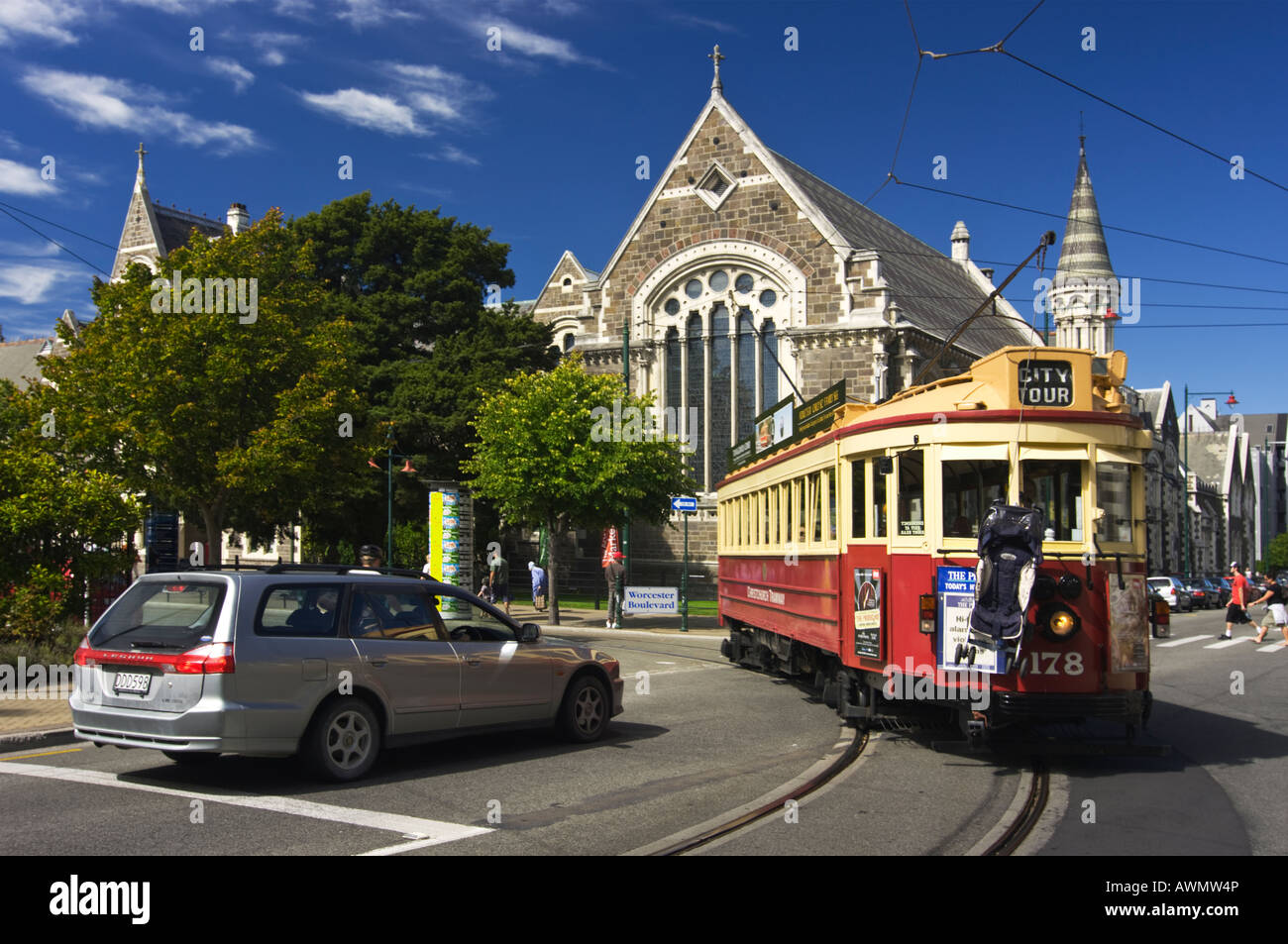 Ein modernes Auto weicht einer Vintage restaurierte Straßenbahn in Christchurch zeigt wie Transport im Laufe der Jahre verändert hat. Stockfoto