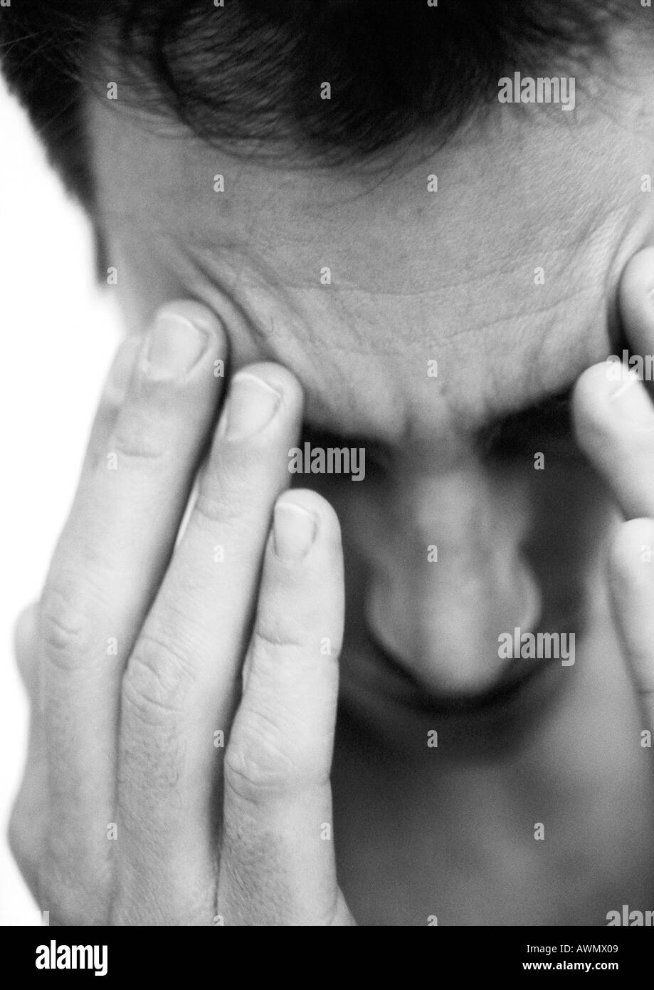 Mann berühren Stirn mit Fingern, Nahaufnahme, schwarz und weiß. Stockfoto