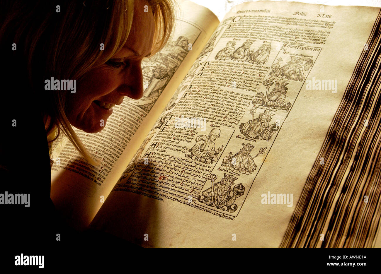 Bibliothekarin Frau untersucht ein uraltes Buch die Schedelsche Weltchronik von 1493 in Brighton Bibliothek seltenes Buch Stockfoto