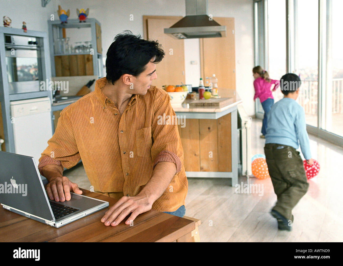 Vater, Rückblick auf die Kinder spielen mit Bällen im Haus. Stockfoto