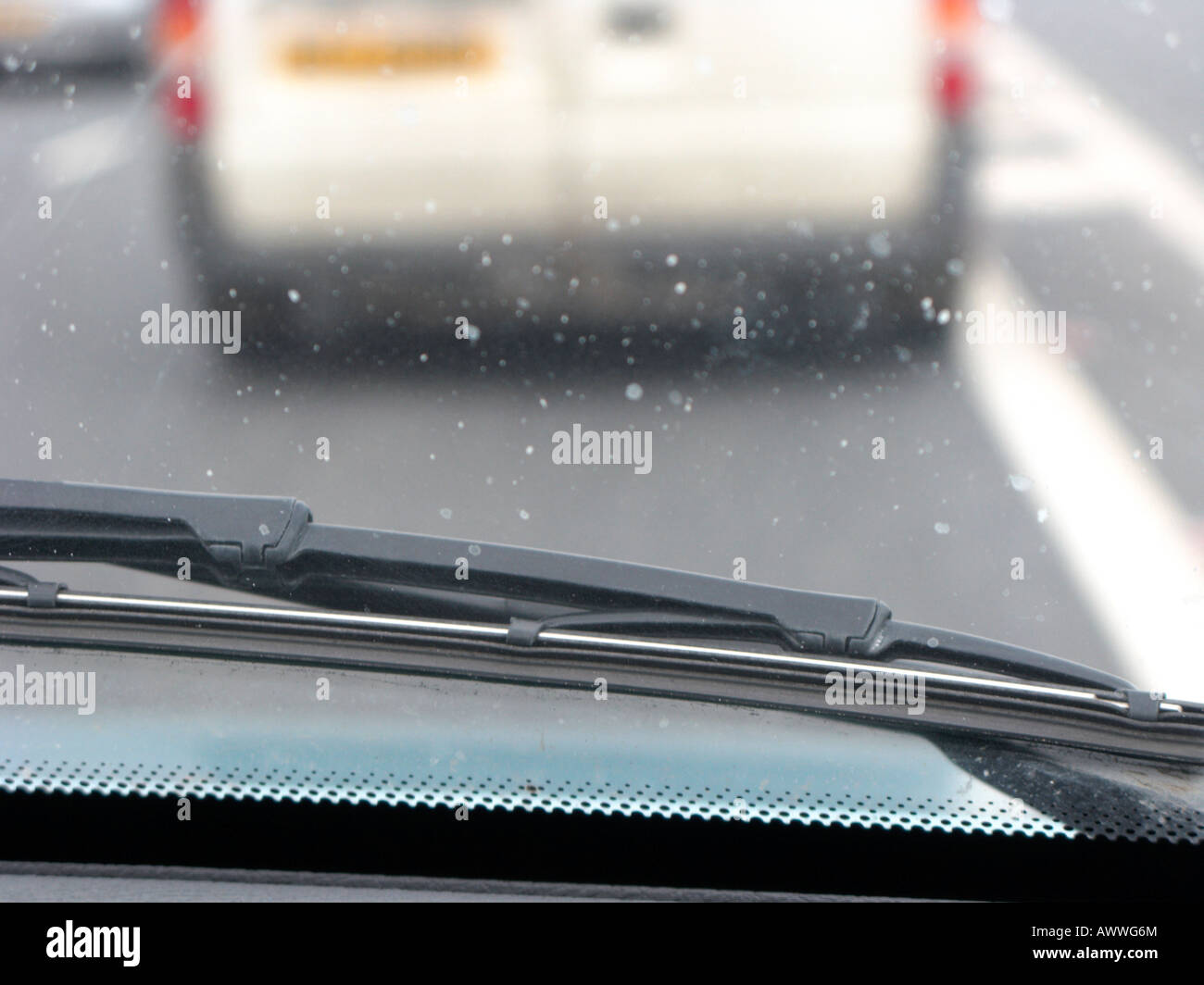 Blick aus einem Auto ein Wischblatt und schmutzige Frontscheibe im Verkehr Stockfoto