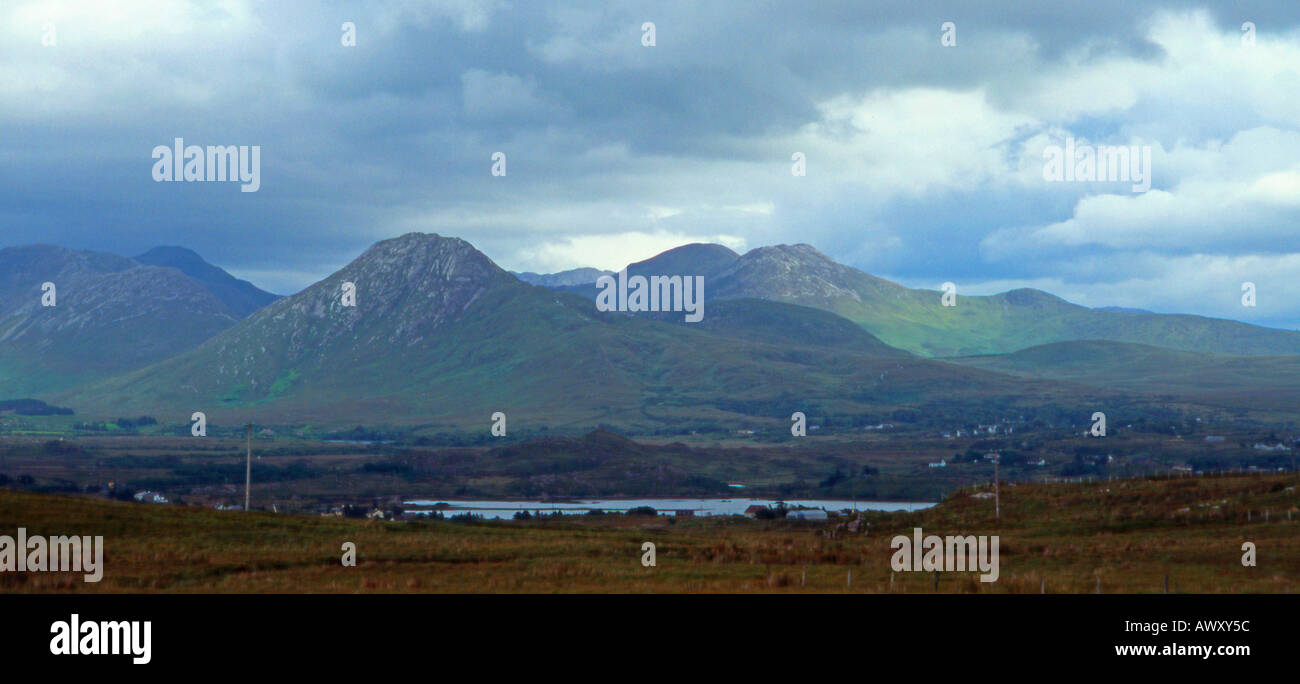 Sonnenlicht und Schatten über die Twelve Bens (Pins), Connemara, Irland von Cleggan Moyard Straße anzeigen Süd. Stockfoto