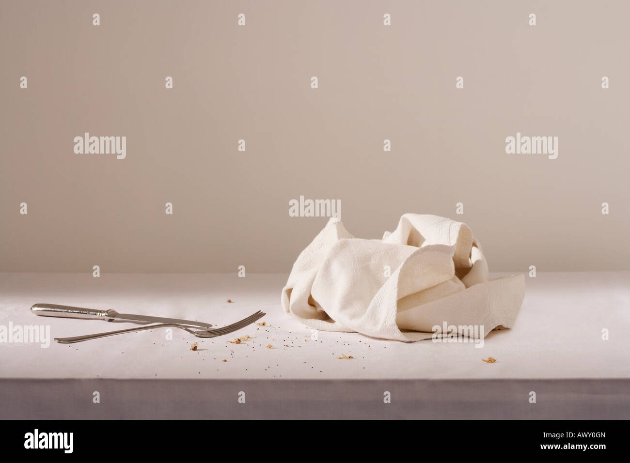 Geschirrtuch, Besteck und Krümel auf dem Tisch Stockfoto