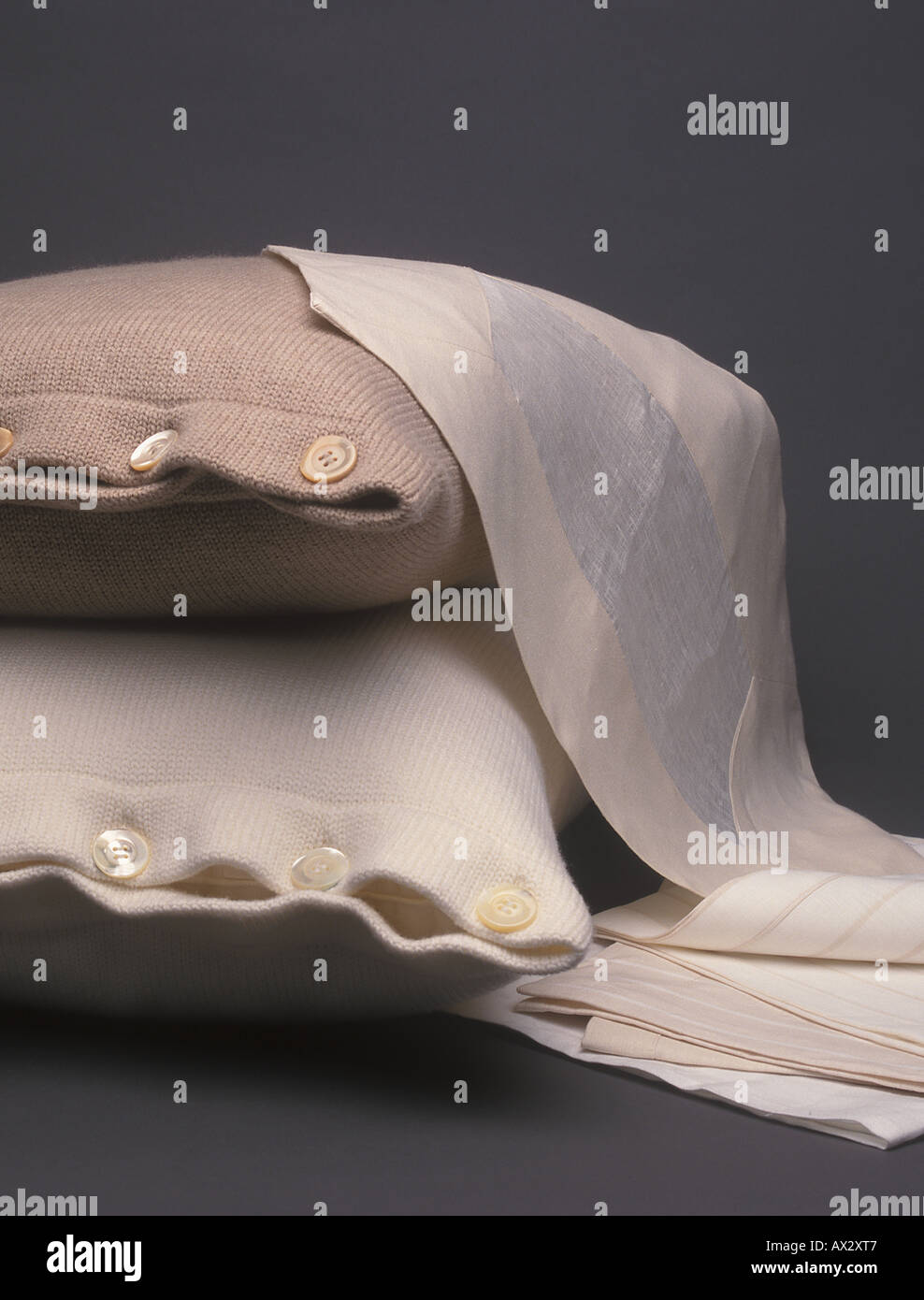 Luxus Haushaltswaren Produkte auf einem dunklen Hintergrund, darunter zwei Kissen und eine Auswahl der Stichprobe Tücher Stockfoto
