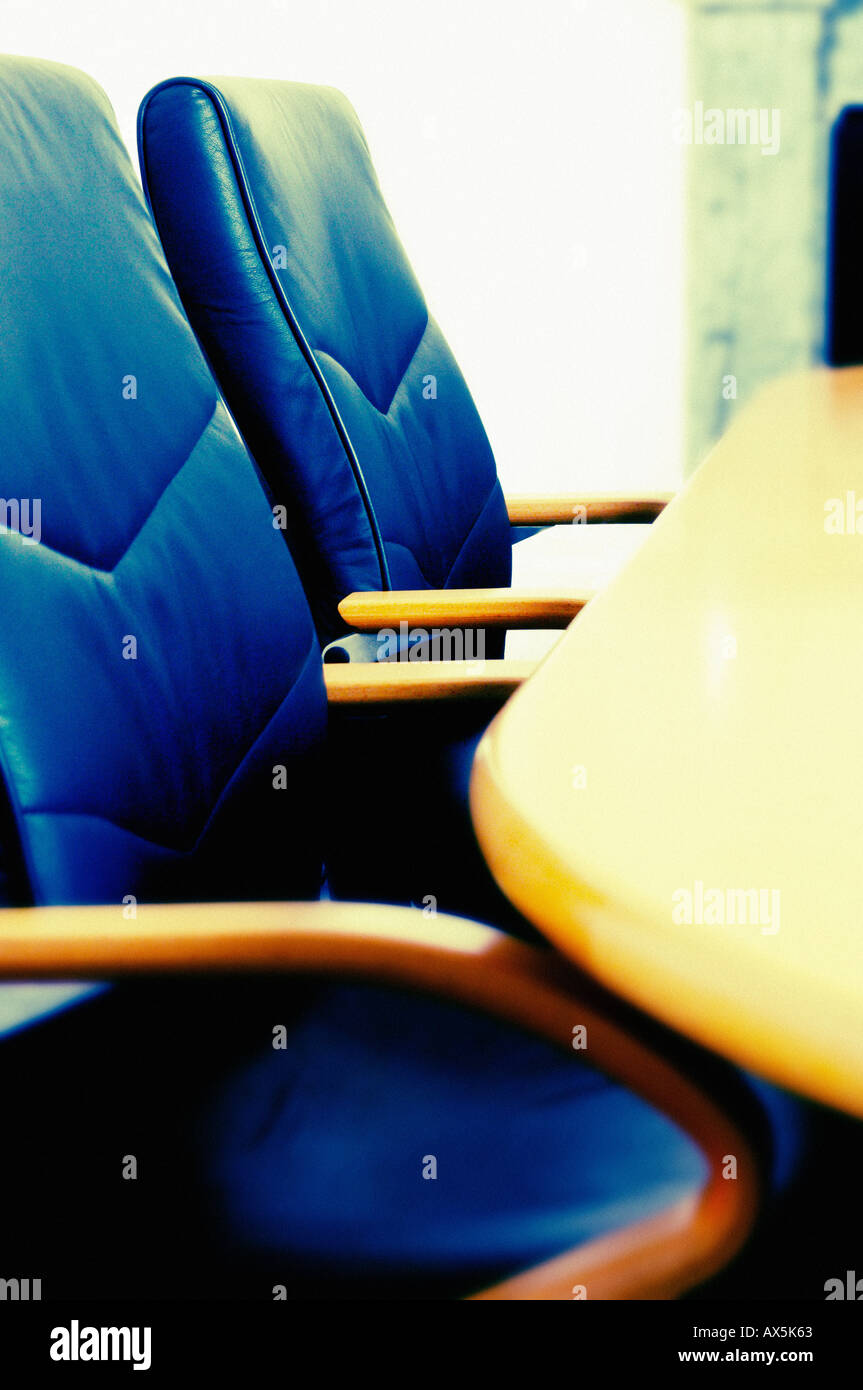 Ledersessel und ein Holztisch in einem leeren Sitzungssaal. Stockfoto
