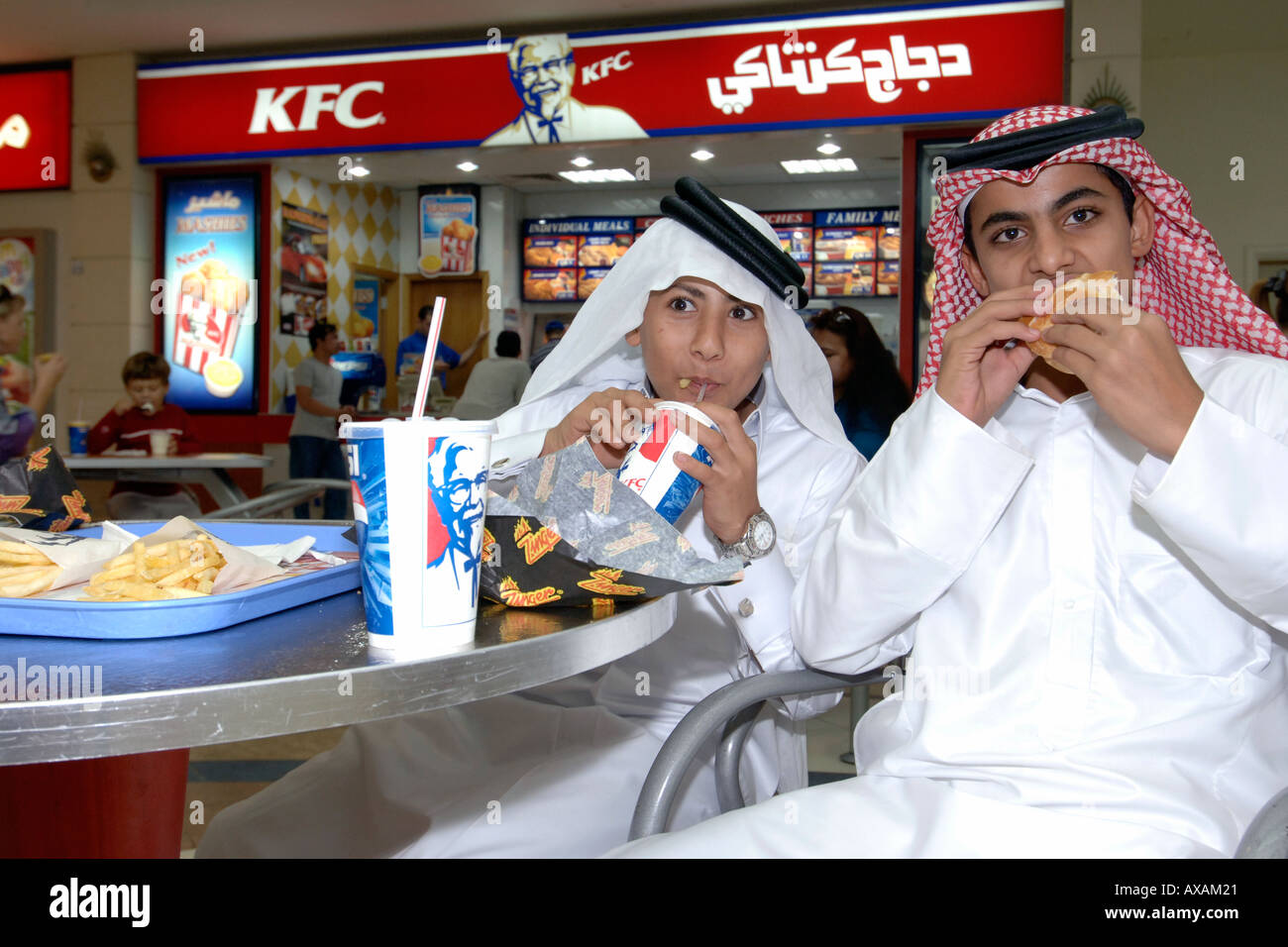 Katar Kinder in traditionellen Outfits Fastfood in einem Einkaufszentrum in Doha. Stockfoto