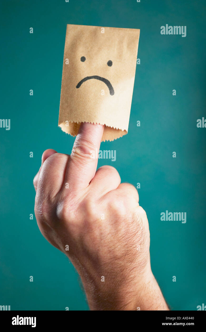 Unglückliche Gesicht Tasche am finger Stockfoto