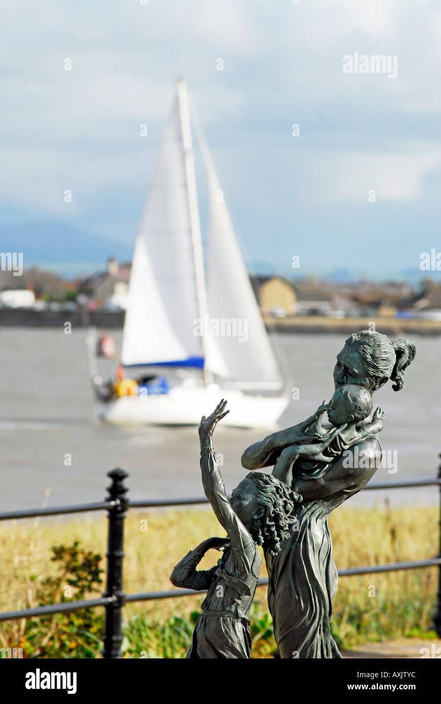 Die Skulptur Willkommen zu Hause von Anita Lafford auf Fleetwood Promenade mit ankommenden Yacht im Hintergrund Stockfoto