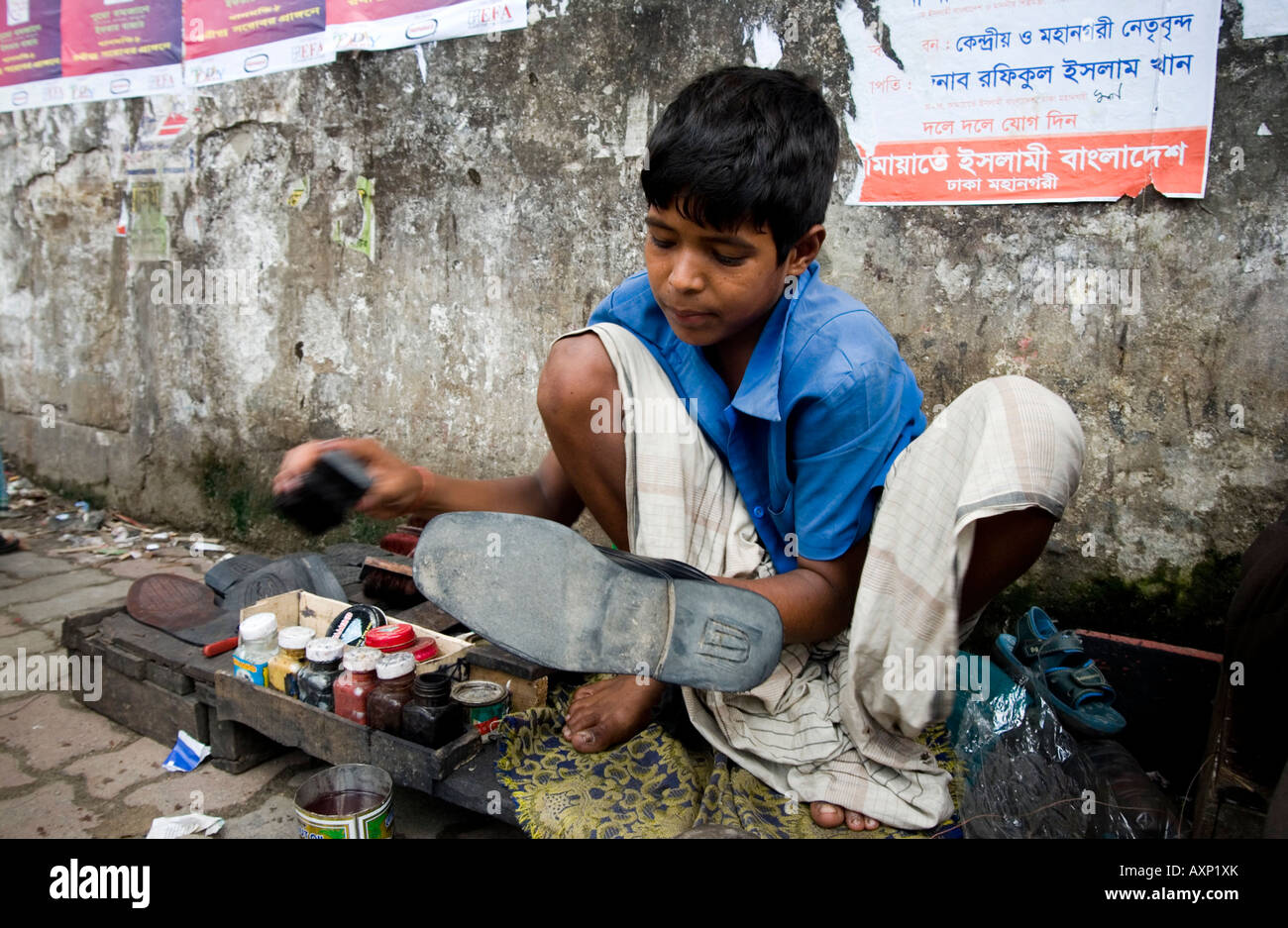 Kleiner Junge als ein Schuhputzservice in Dhaka, Bangladesch Stockfoto