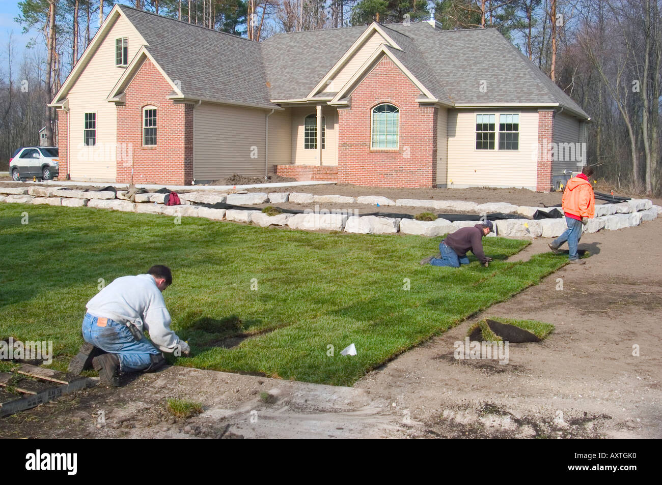 Arbeiter legen neuen Rasen mit Rasendecke im Wohnungsneubau nach Hause Stockfoto