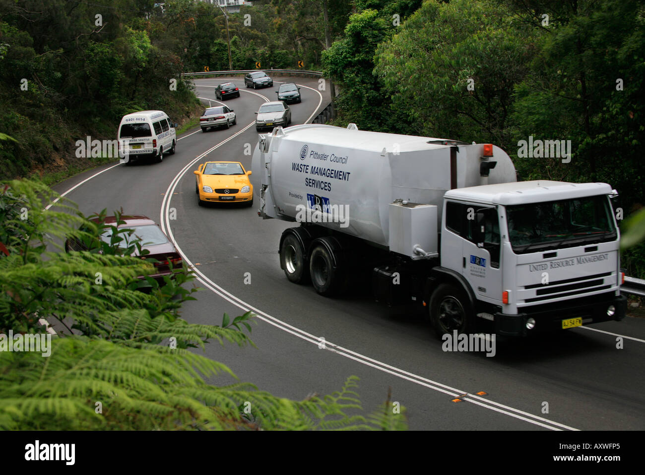 Eine Entsorgung LKW Verzögerungen Verkehr hinter sich auf dem gewundenen S beugen Straße in der Nähe von Avalon auf Sydney s nördlichen Strände Australien Stockfoto