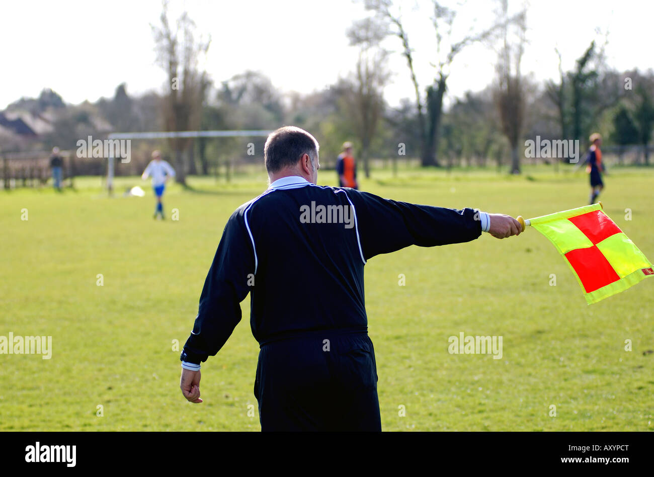 Linienrichter wehende Flagge in Sunday League Fußballspiel, UK Stockfoto