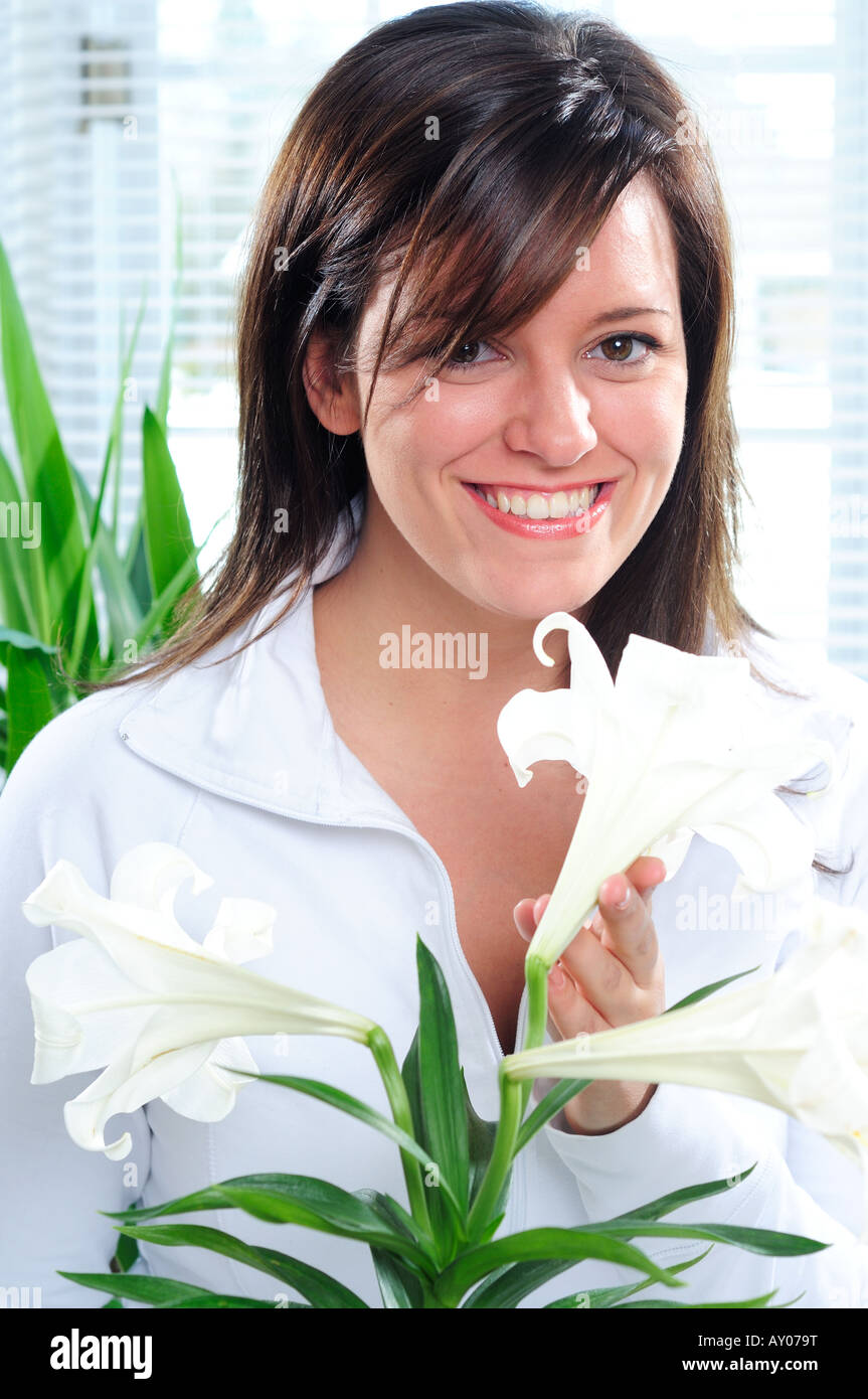Junge Frau riechen eine Ostern Lilly Stockfoto