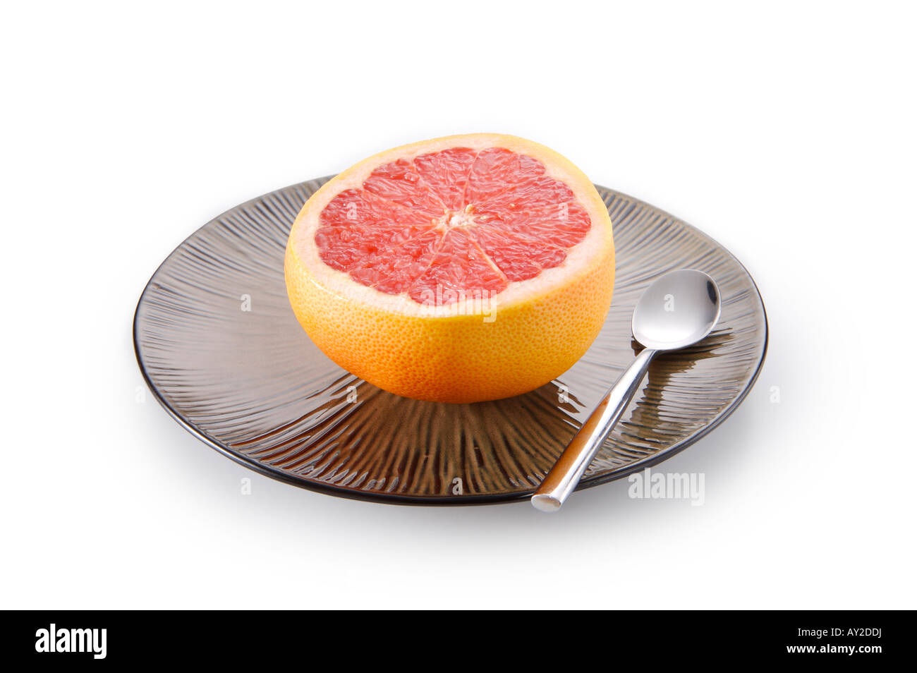 Grapefruit auf Teller mit Löffel. Stockfoto