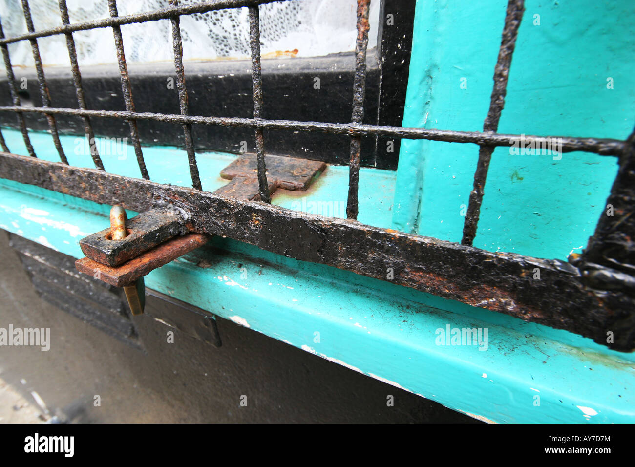 Rostige Schlossriegel und Grill auf alten Schaufenster für Sicherheit. Stockfoto