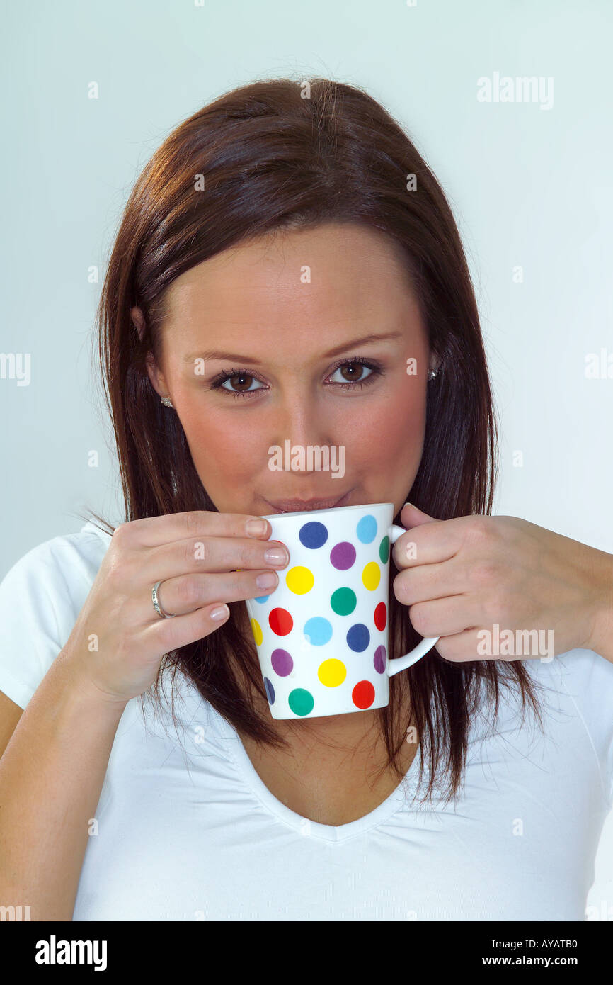 Porträt der jungen Frau aus gefleckte Tasse trinken Stockfoto