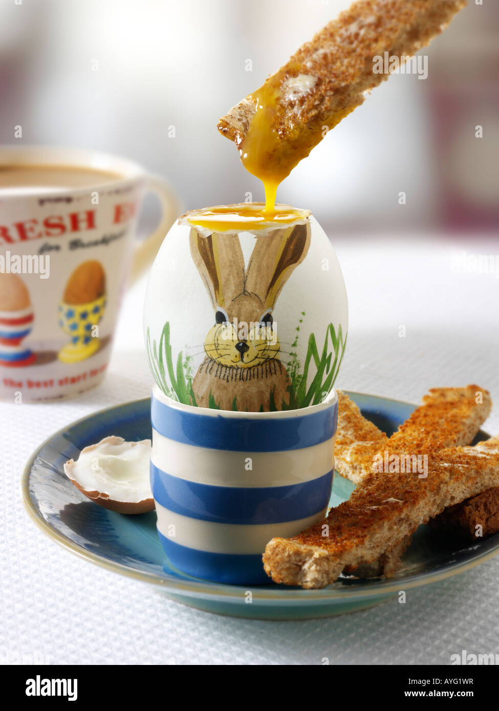 Traditionelle handbemalte dekoriert gekochte Oster hase Ei in ein Frühstück mit Toast, getaucht in das Ei Stockfoto