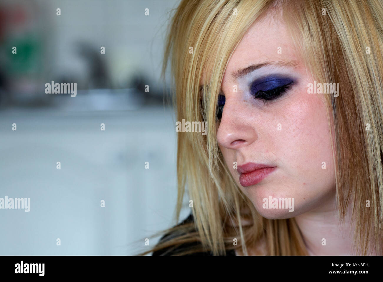 Nahaufnahme des Gesichts von teenage blonde kurzhaarige Frau sitzt weinend in ihre Küche ein Stockfoto
