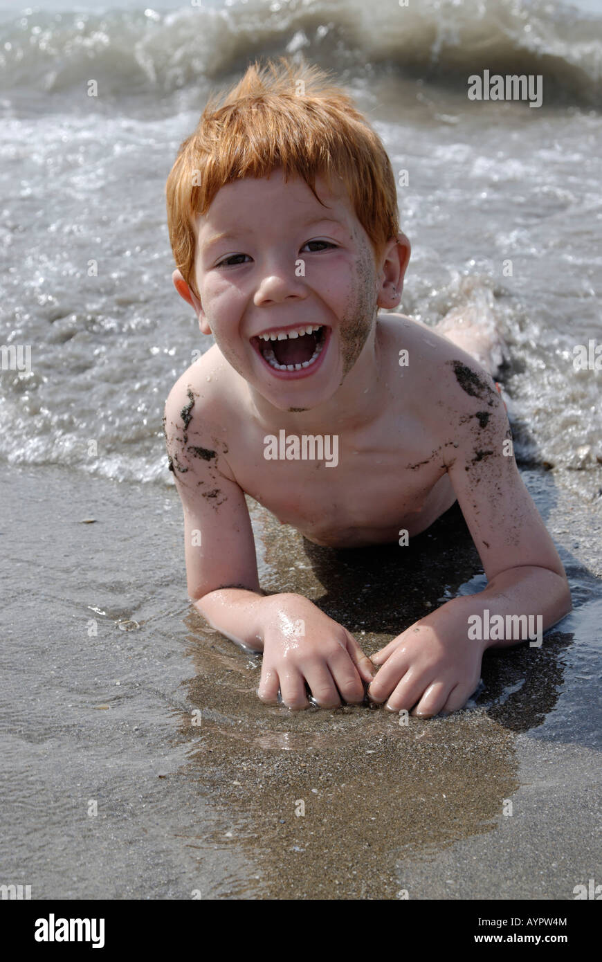 Junge Verlegung im Wasser, Spaß am Strand Stockfoto