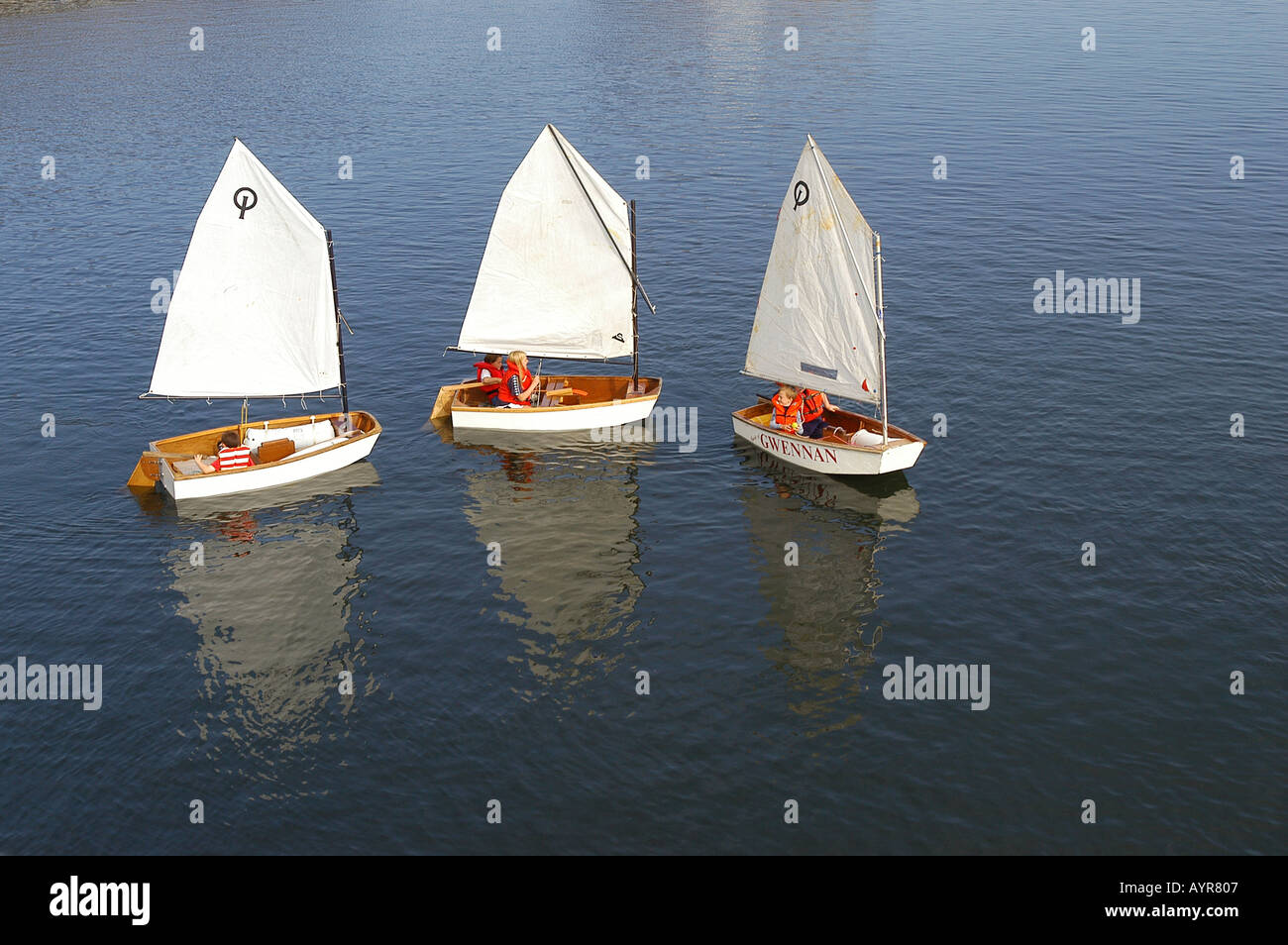 Kinder Segeln in kleine Yachten mit Gwennan Logo in Swansea Marina West Glamorgan South Wales Großbritannien Stockfoto