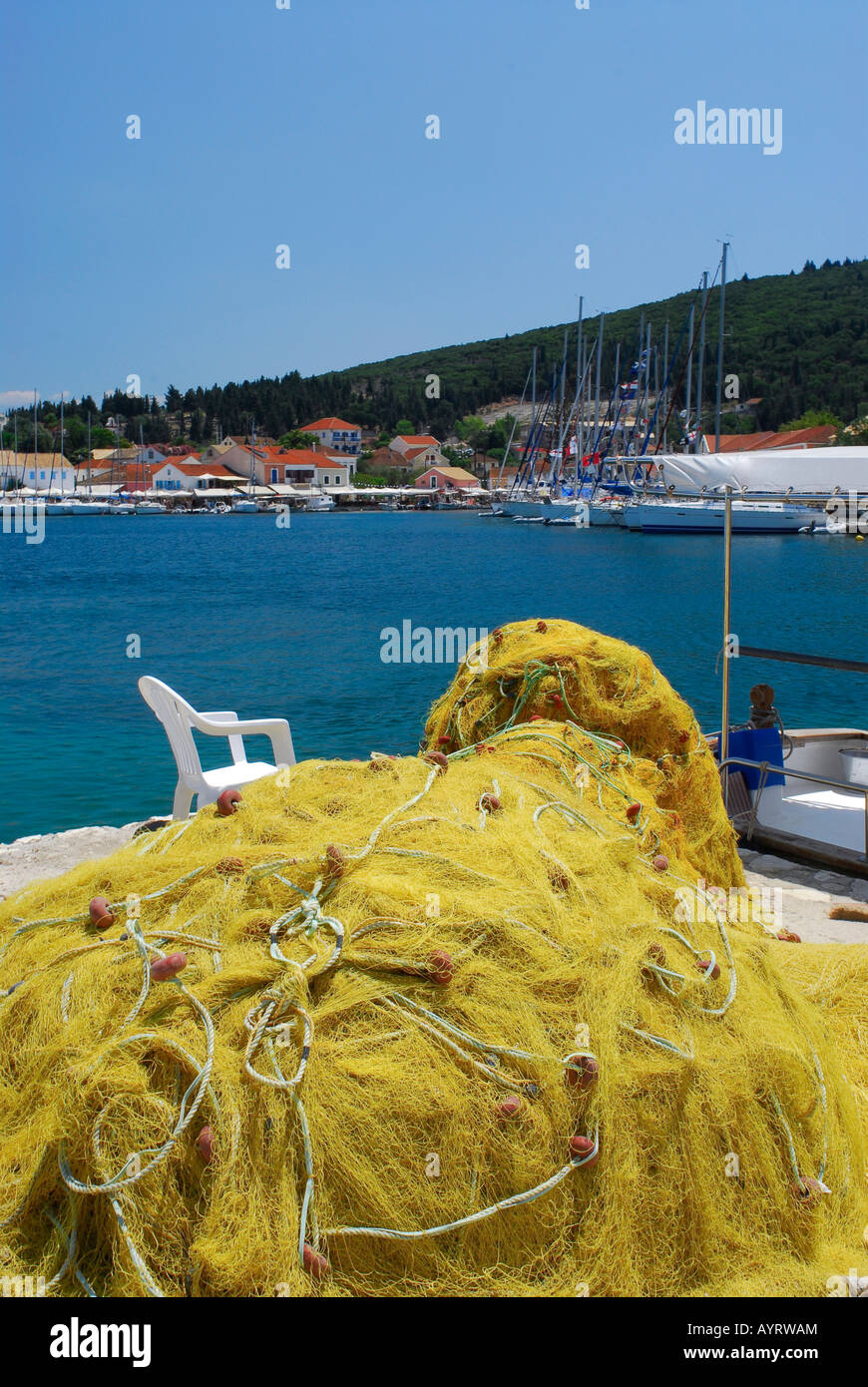 Fischernetze und Blick auf den Hafen in Fiscardo, Kefalonia, Ionische Inseln, Griechenland Stockfoto
