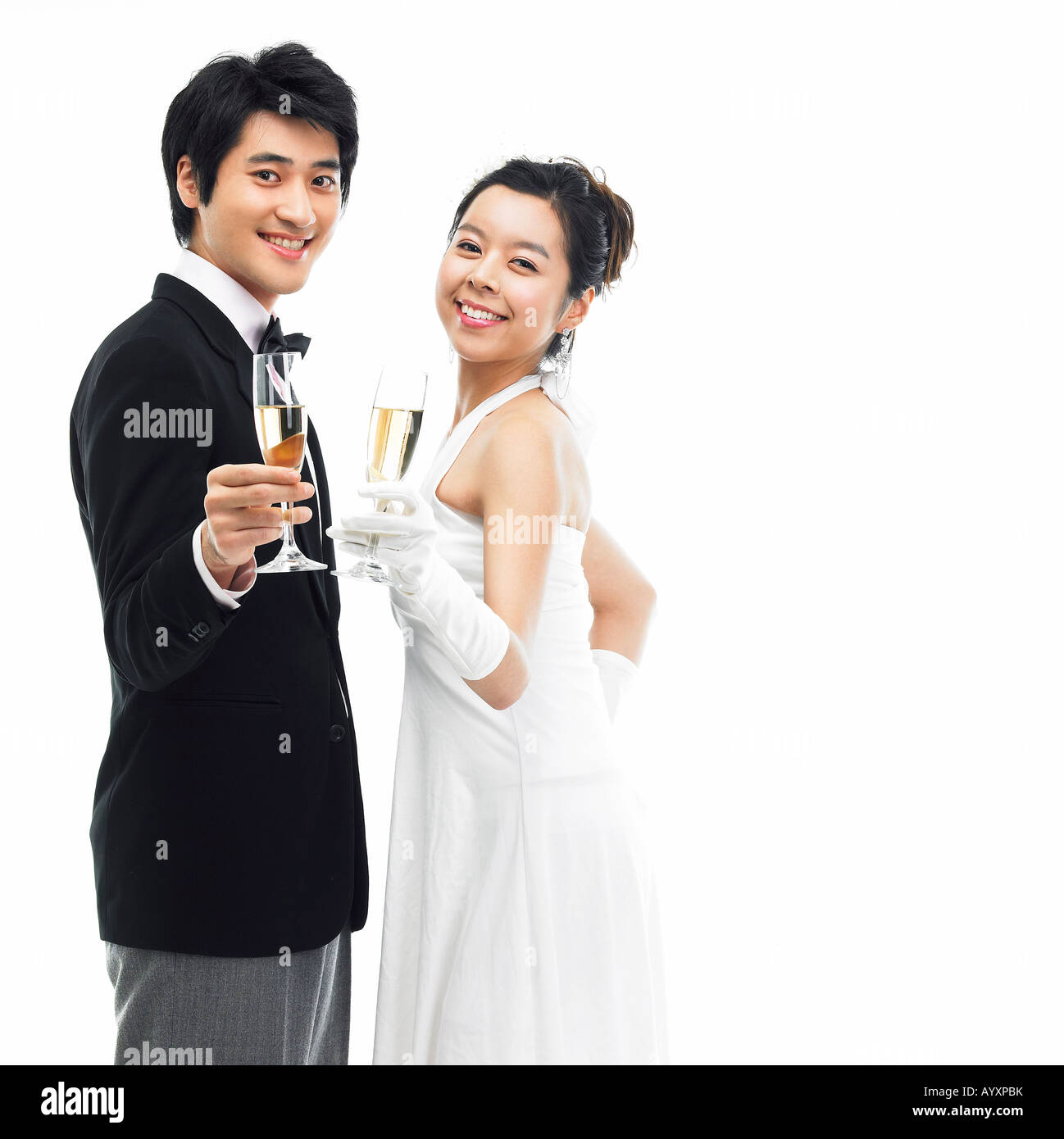 ein paar in Anzug und Kleid mit einem Champagner Glas Stockfoto