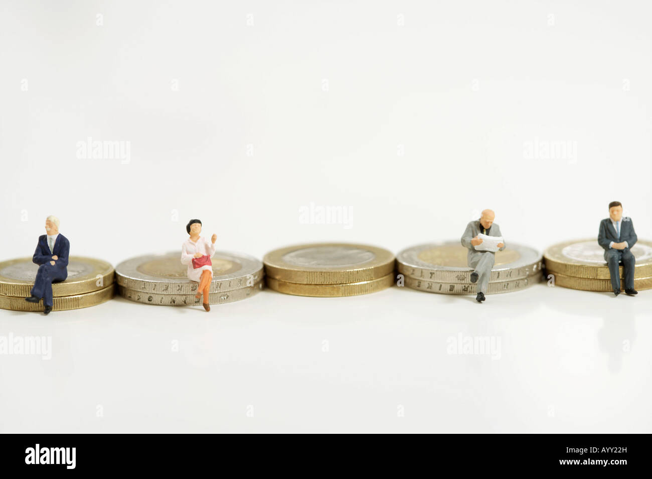 Unternehmer-Figuren sitzen auf Münzen Stockfoto