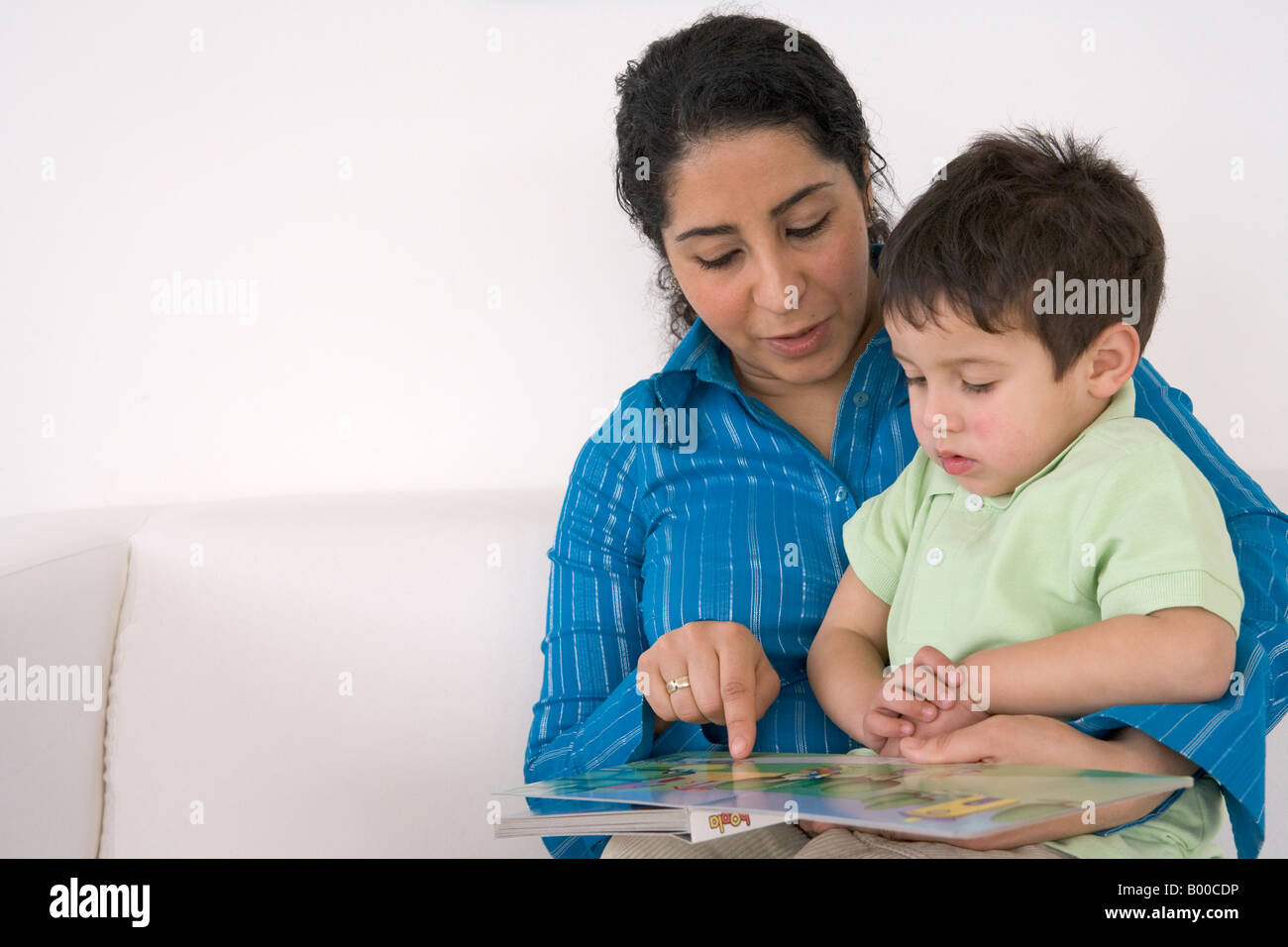 Mutter ist für ihren Sohn ein Buch lesen. Stockfoto