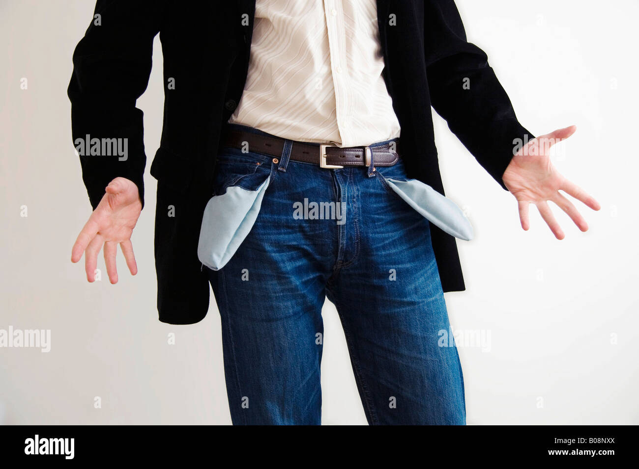 Mann in taillierten Blazer und Jeans alarmiert durch seine eigene leeren Taschen Stockfoto
