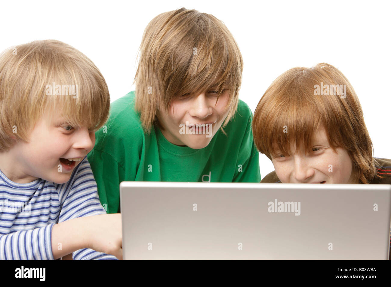 Drei Jungs sitzen vor einem Laptop, 10, 12 und 13 Jahre alt Stockfoto