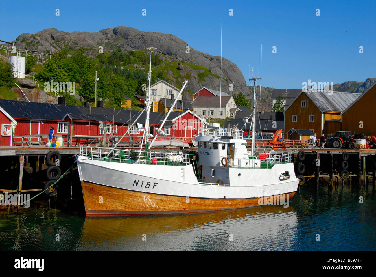 Hölzerne Angelboot/Fischerboot gebunden bis zu einem Anlegesteg und rot aus Holz "Rorbu" Häuser in Nusfjord, Lofoten Inseln, Norwegen, Skandinavien Stockfoto
