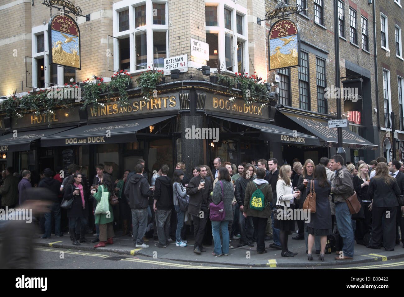 Trinker spill heraus auf der Straße vor dem Hund und Ente Pub in Soho in London Stockfoto