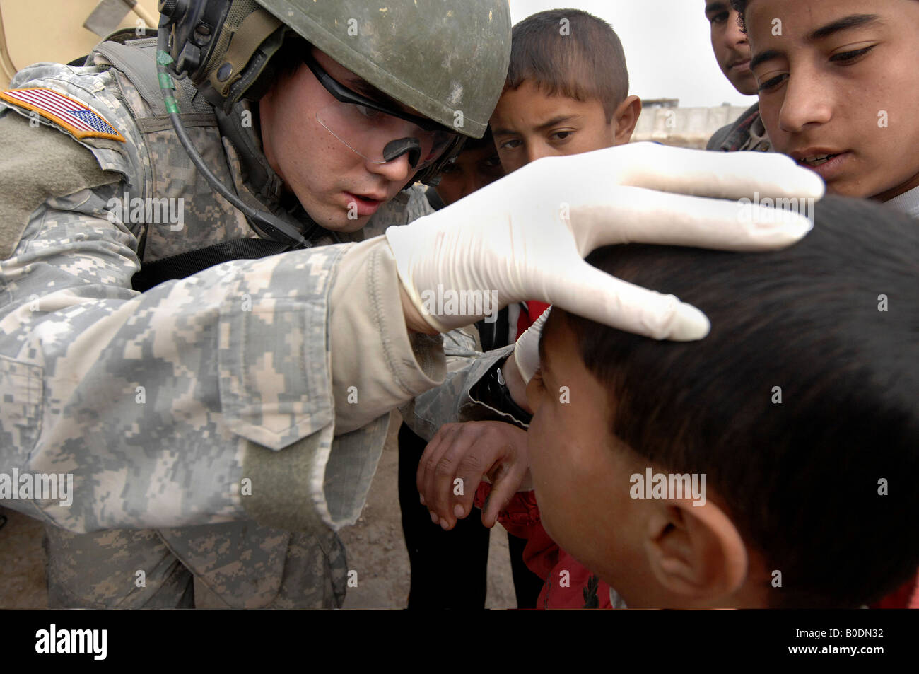 U S Army Spc Marcel Roth untersucht eine irakische Kinder in der Meshahadah Provinz Irak 27. Januar 2008 Stockfoto