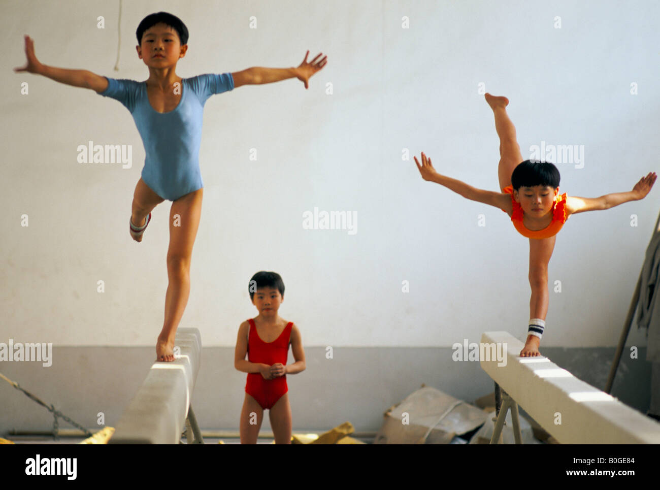 Kinder üben am Schwebebalken an einer Schule für Turner, China. Stockfoto