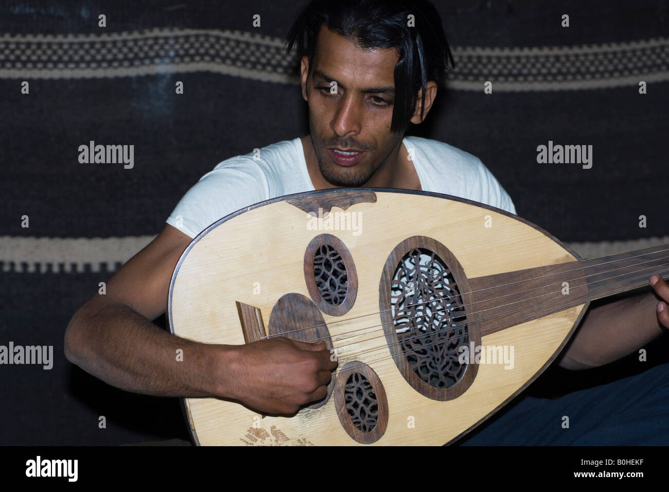 Beduinen spielen die Laute in einem Beduinen-Zelt, Wadi Rum, Jordanien, Naher Osten Stockfoto