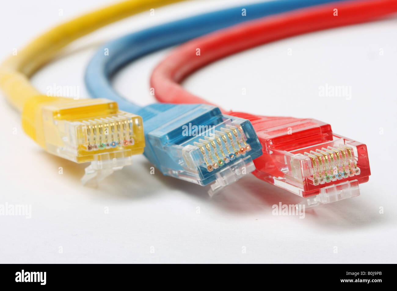 Kategorie 5-Netzwerk-Kabel isoliert auf weißem drei verschiedene Farben rot blau und gelb Stockfoto