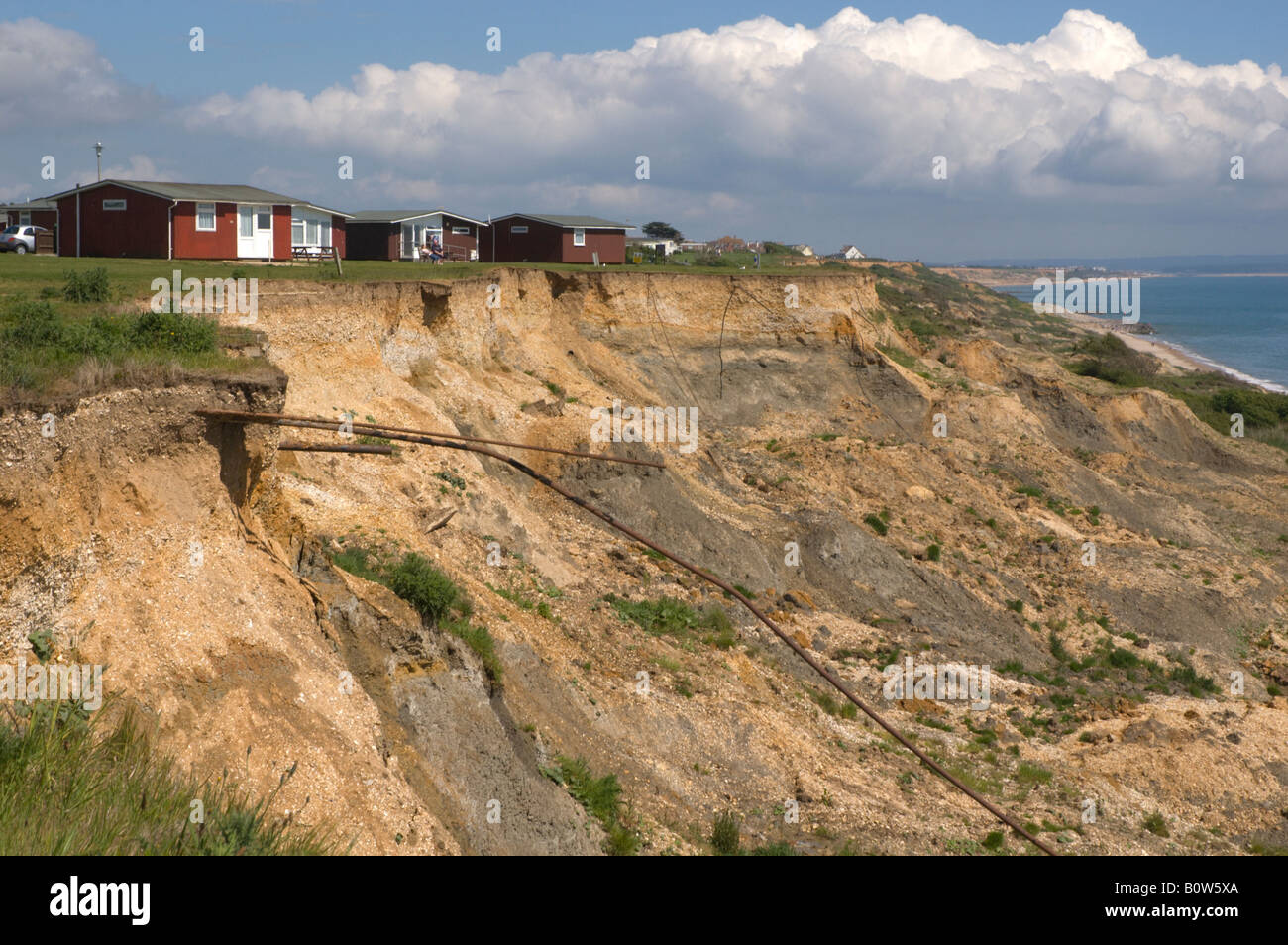 Ferienhäuser bedroht durch Küstenerosion auf zuvorkommend, Dorset, UK 2/2 Stockfoto